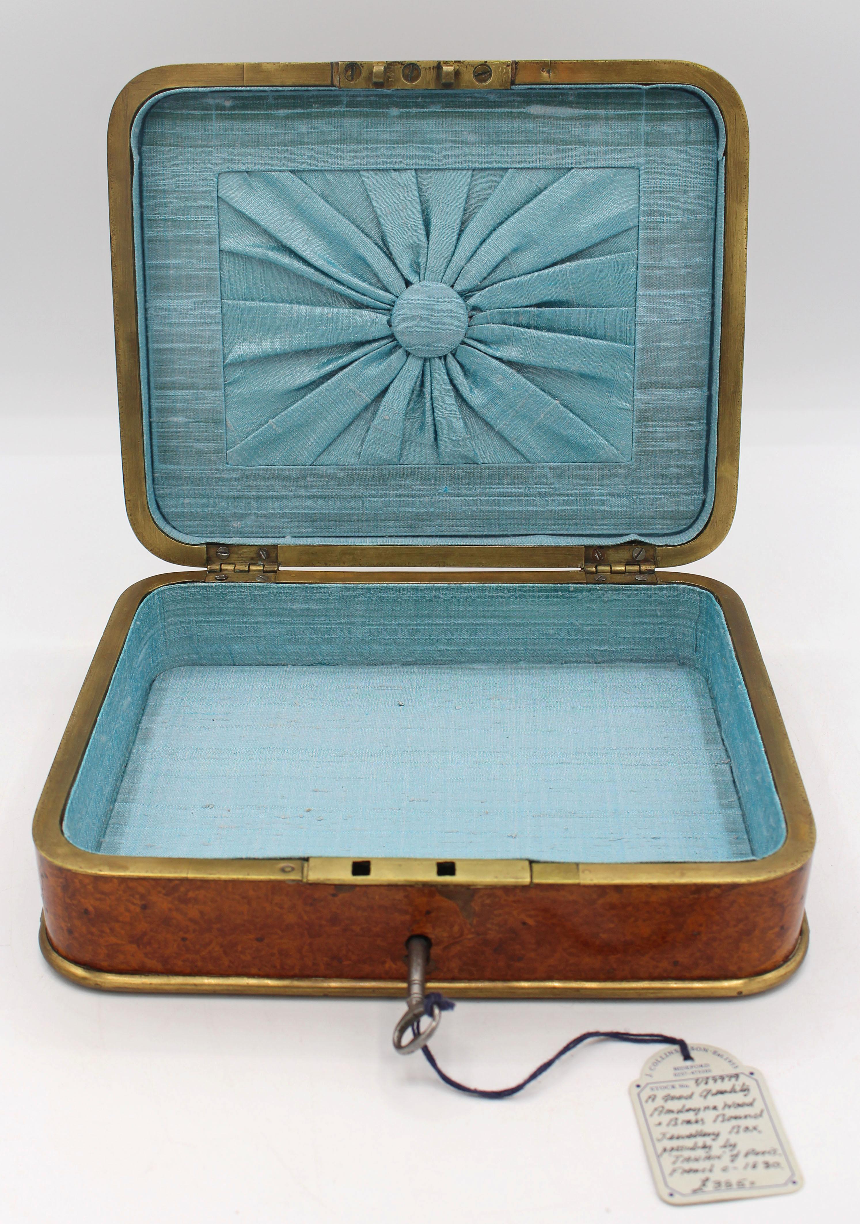 Joyero encuadernado de amboyna y latón de circa 1830 atribuido a Tahan de París. Forro elegante. Con llave de trabajo. Procedencia: Colección del Dr. John Fryer, Londres y Chapel Hill, comprada al importante J. Collins & Son, Bidebord, Devon,