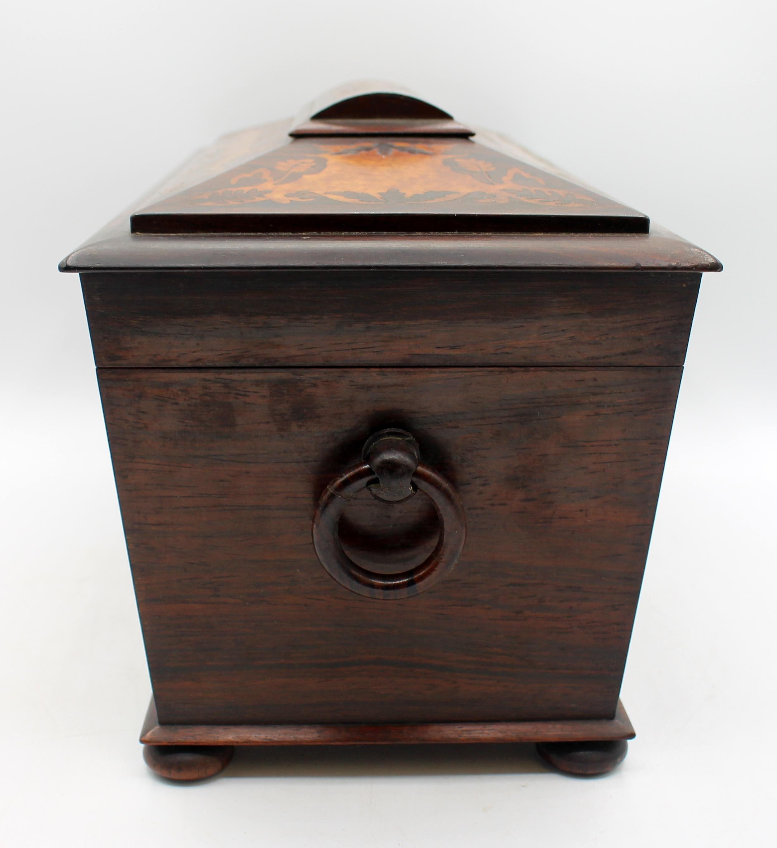 Circa 1830 William IV period tea caddy, English. Outstanding quality. Amboyna burr wood with rosewood - bird, floral & naturalistic inlay designs. Sarcophagus form. Turned wood feet & treen ring handles. The inner caddies conform to the exterior