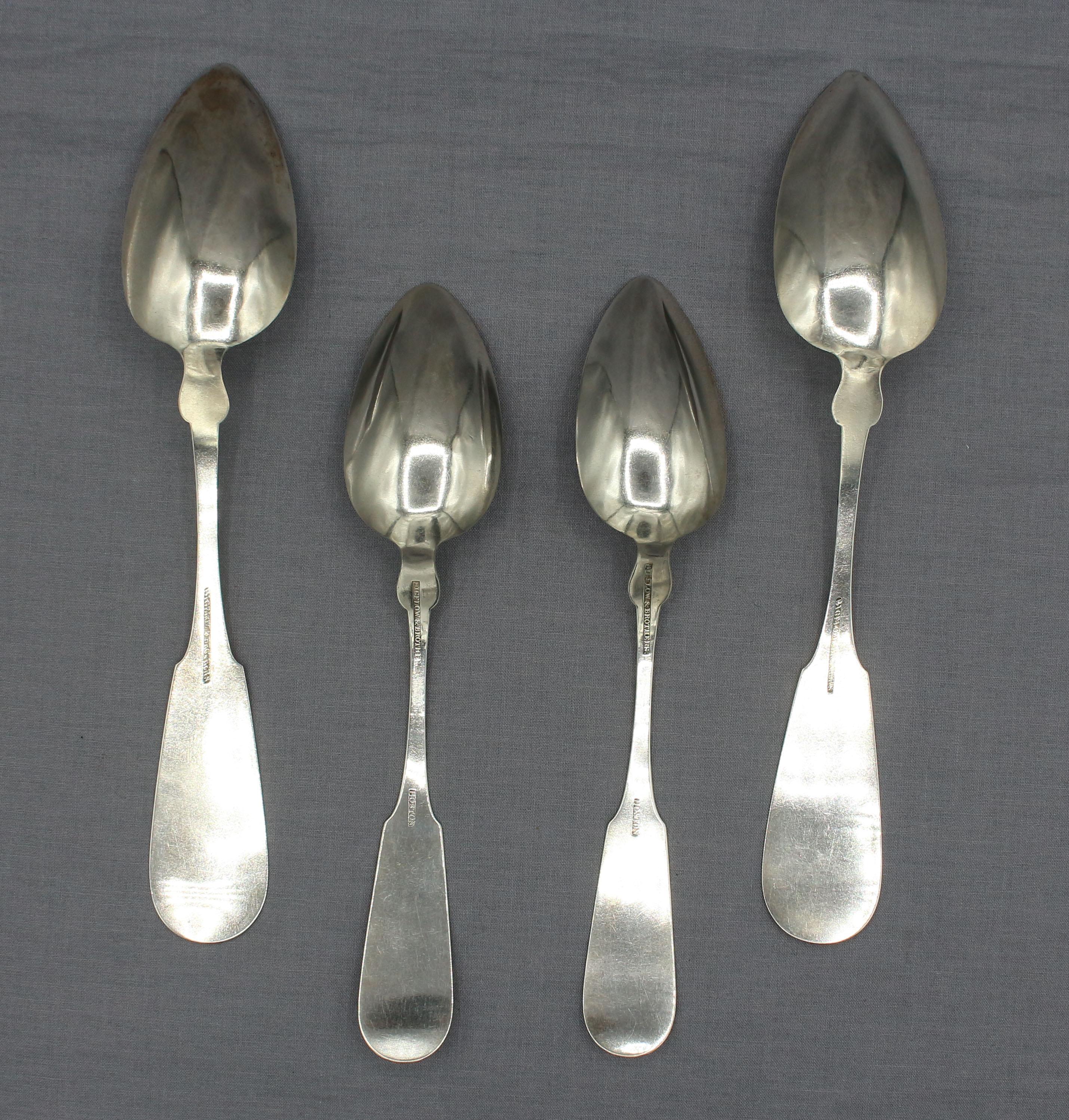Circa 1840-50 set of 4 coin silver serving spoons by Bigelow & Brothers, Boston, MA. 2 table & 2 large serving size. John, Abram & Alanson Bigelow. Made with 2 sets of back stamps, one including Boston. Fiddleback plain with chamfered shoulders.