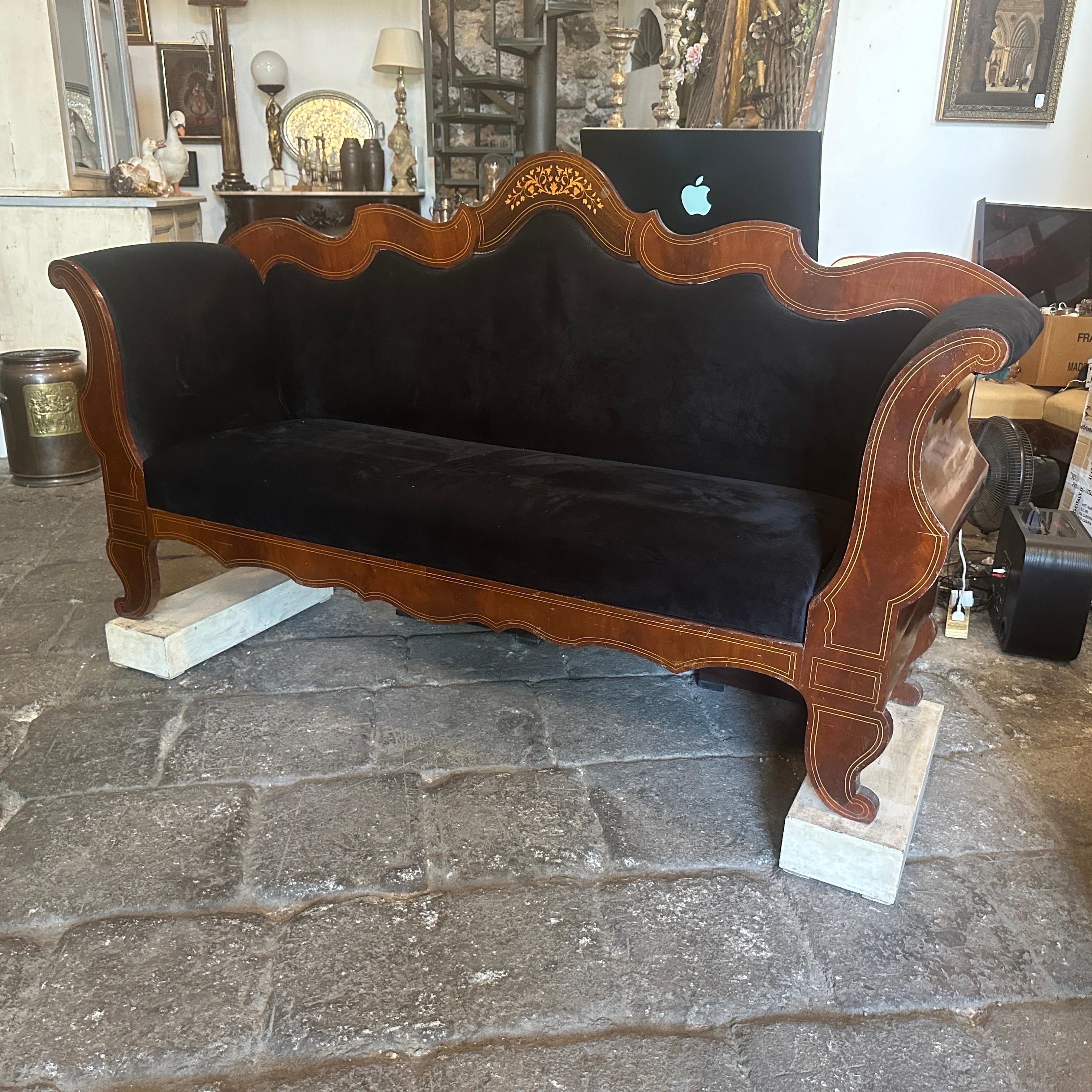 This Sicilian sofa is a piece of furniture that embodies the elegance and craftsmanship of the Charles X period, which was prominent in France during the early 19th century. The sofa's frame is crafted from selected mahogany wood mahogany and maple