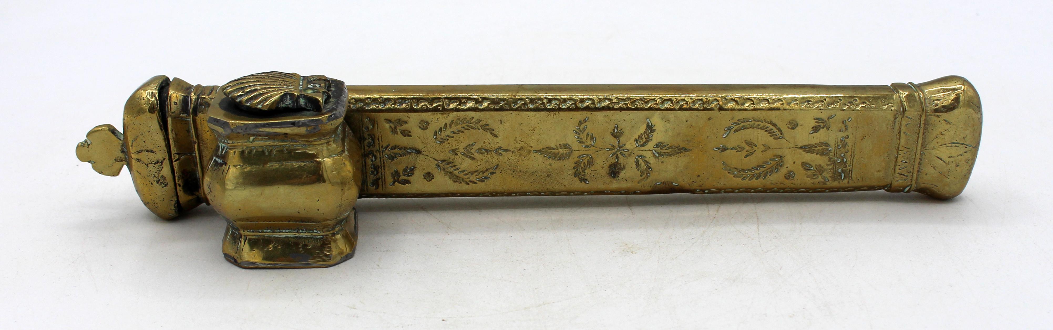 Circa 1850 Middle Eastern Islamic brass inkwell & pen case (Qalamden). Solid brass with cast parts. The case's sides are engraved with geometric designs.
9.5