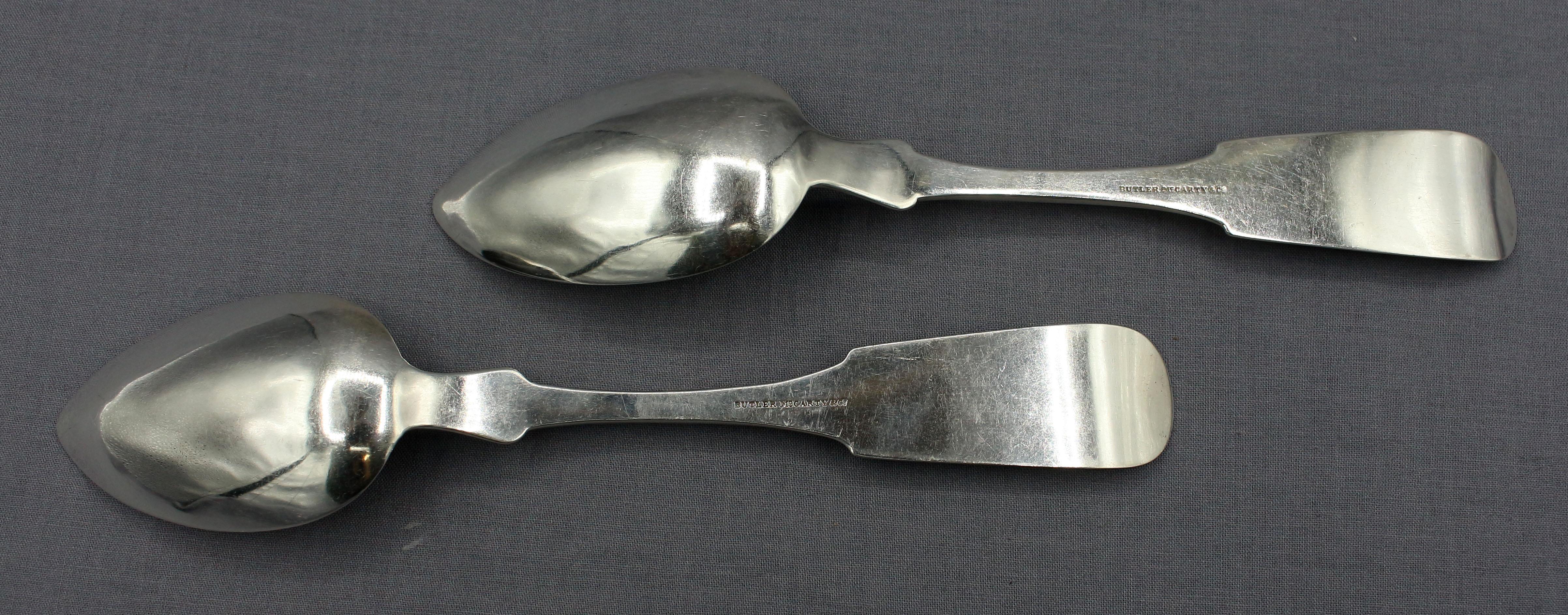 Circa 1850 pair of coin silver serving spoons by Butler & McCarty & Co, Philadelphia, PA. Exceptionally heavy fiddlebacks with upturned tip & chamfered shoulders. Monogram 