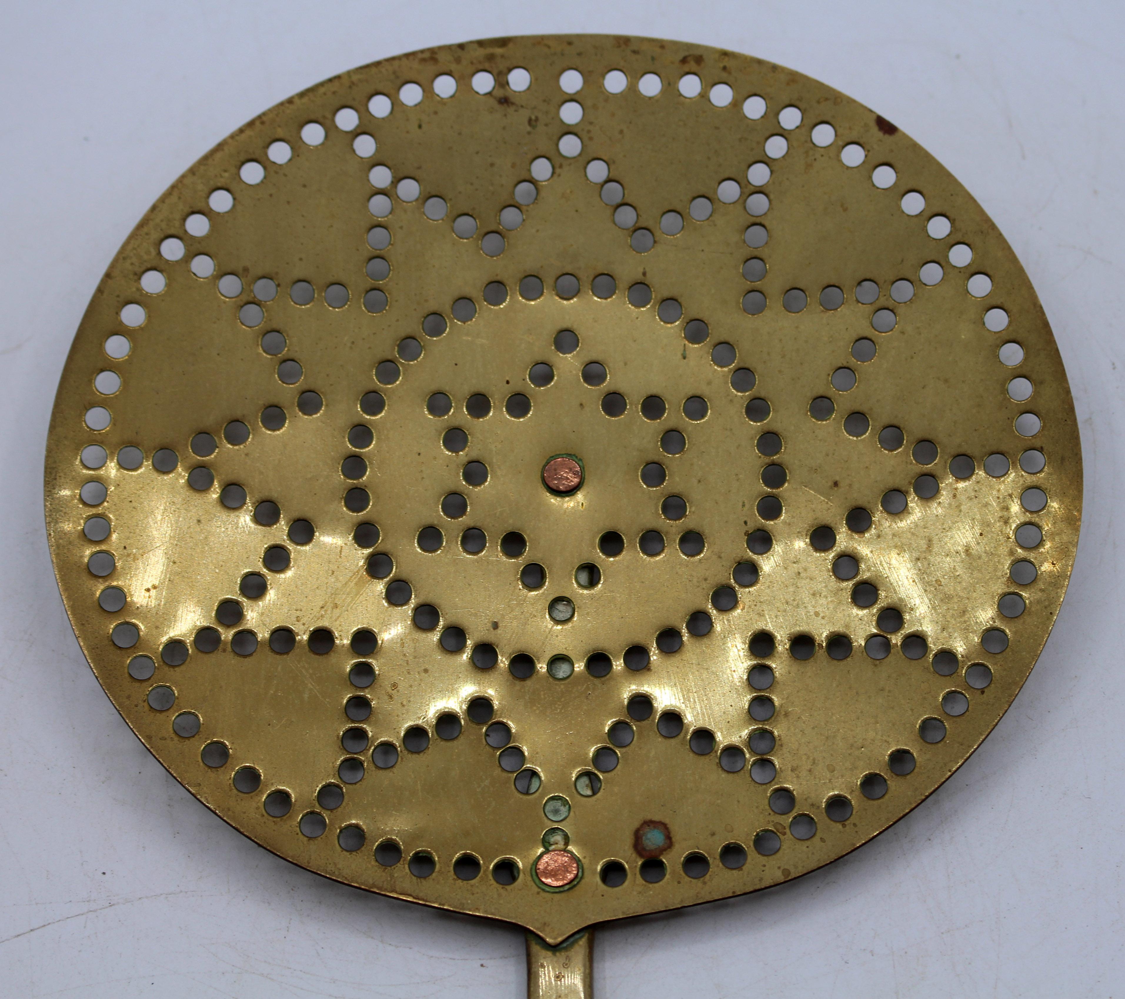 Circa 1860-80 English brass skimmer. Concentric circles & star punch work motif. Brass rivets. Shaped handle.
21.75