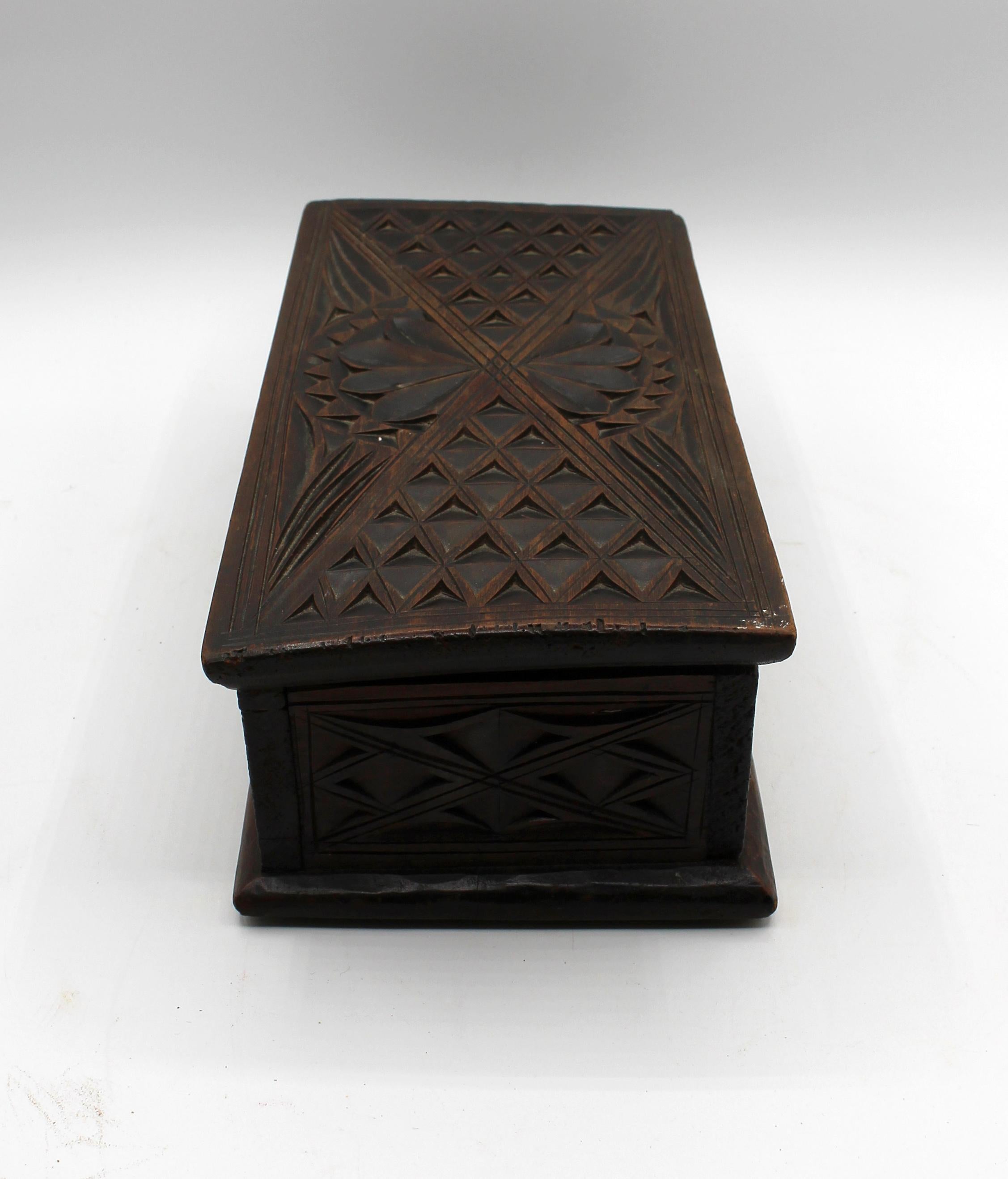 Circa 1860-80 Gothic Revival carved box, English or European. Lindenwood carved with diamond lattice panels, the top with a flower head. Leather lining added later. A wonky later latch lacks hook for closure. Warp cupping the top at left front &