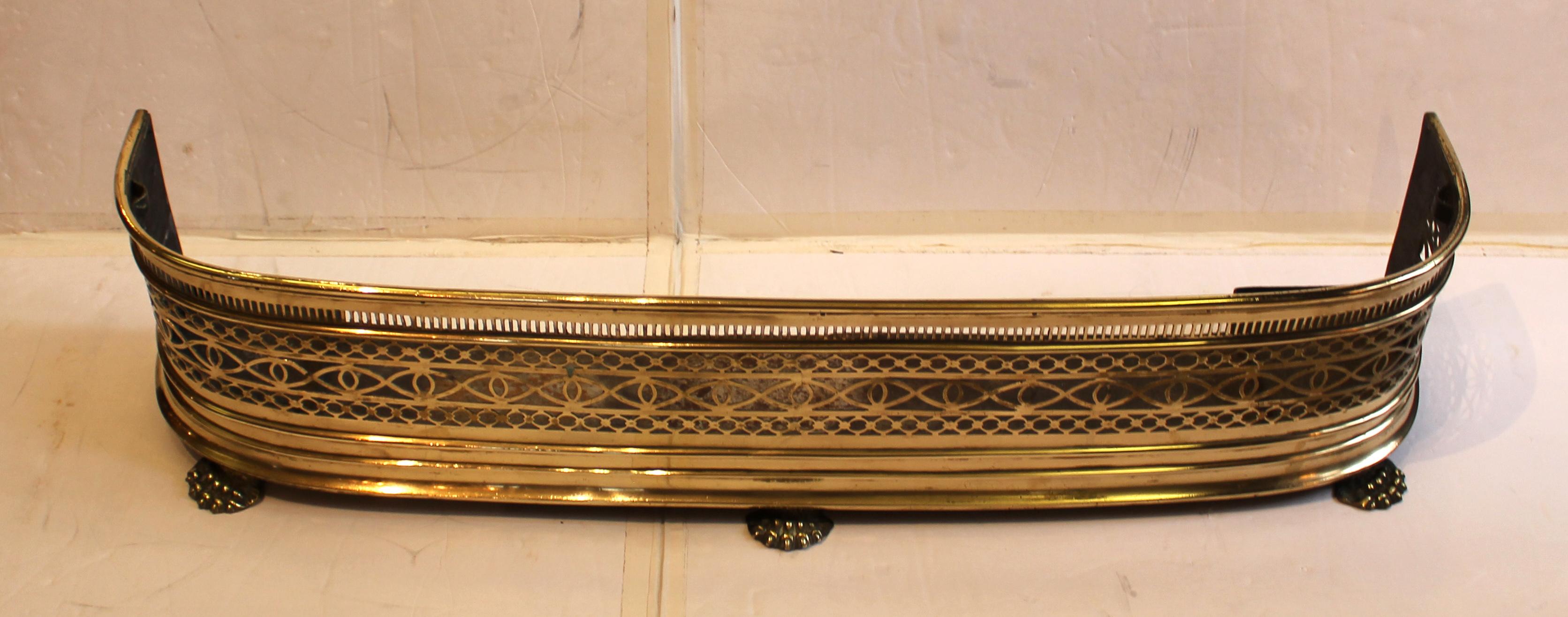 Circa 1860 brass fire fender with integral tool holders, England. Lion's paw feet. Scrolling, pierced body. Integral hearth guard. Rare form with the original, integral fire tool holders. Two breaks in cutwork - center/right of fender.
43.5