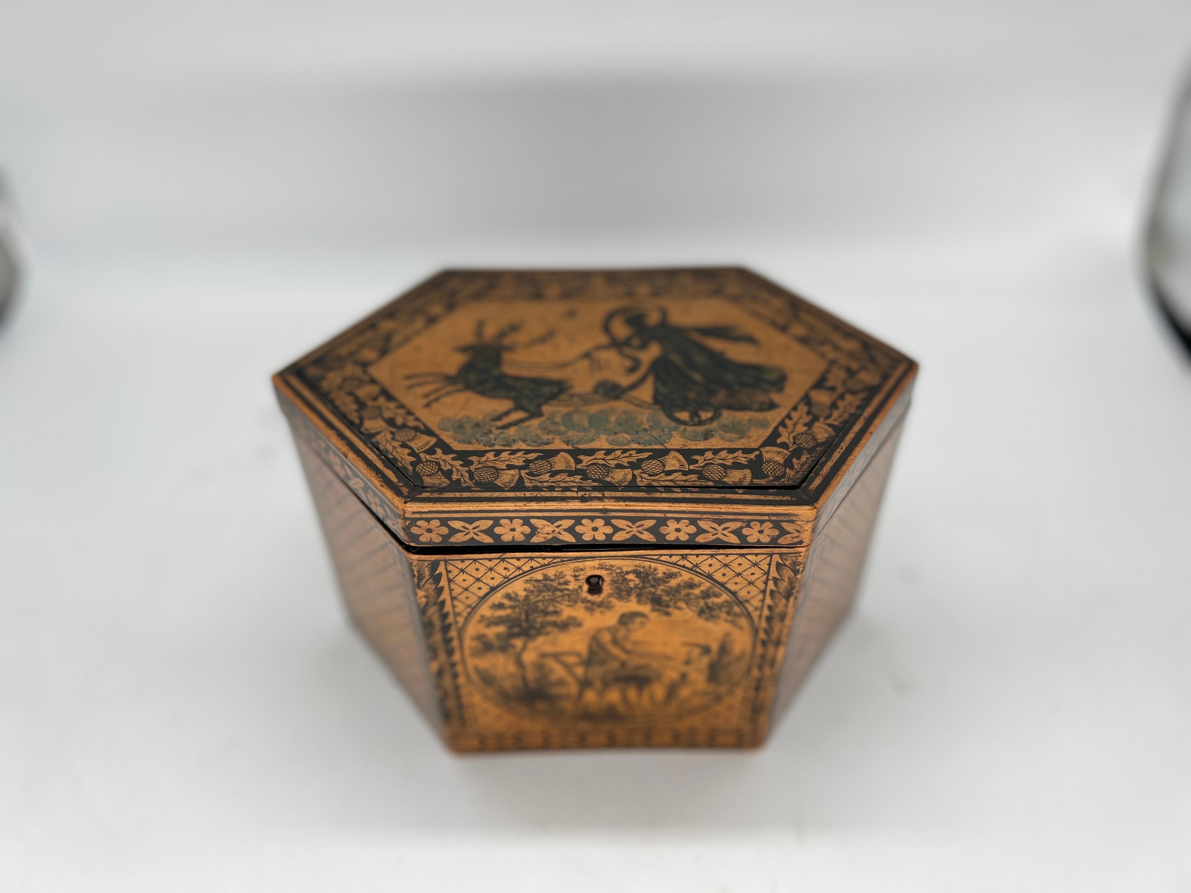 Anglais, vers 1870.

Boîte à thé de forme hexagonale en faïence de Tunbridge et en plumasserie de la Régence. Le sommet est décoré d'un goût néoclassique et représente la déesse Cérès couchée sur son char stylisé. Entouré de glands et de feuilles,