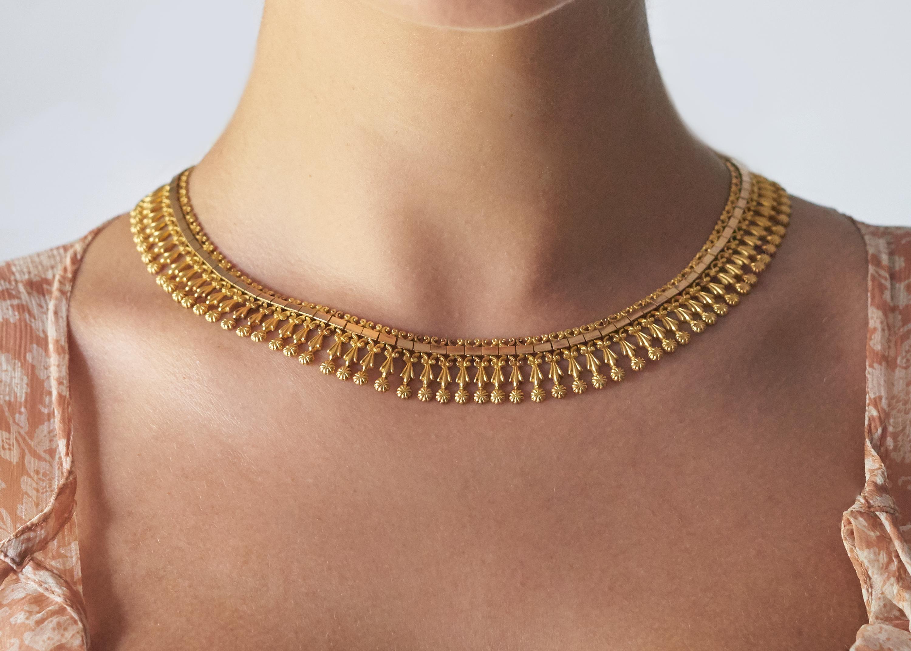 A delicate and elegant 18 karat yellow and rose gold fringe necklace, France, c. 1870. 

Stamped with maker's mark and French assay mark. 
