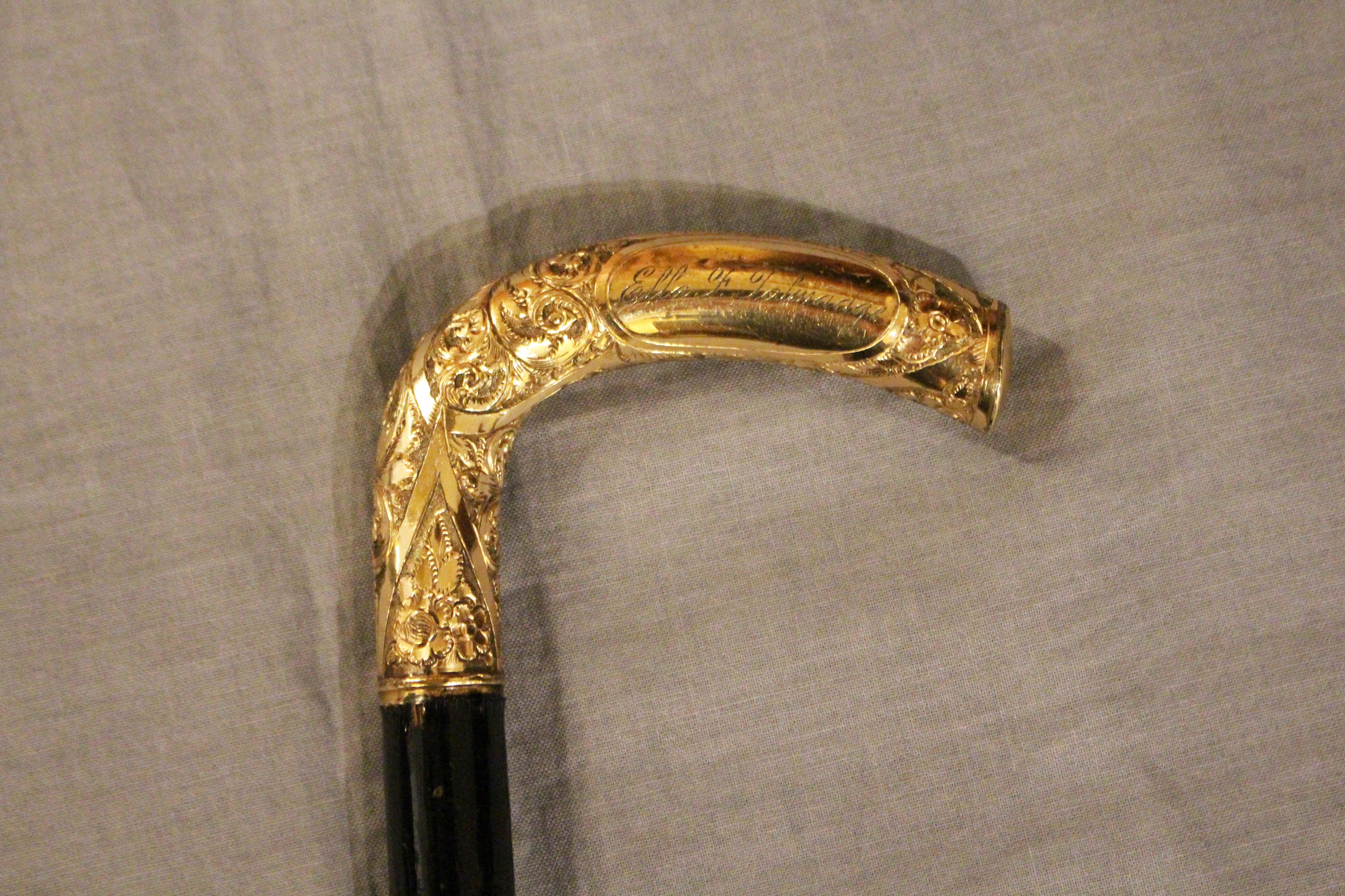Circa 1870s Victorian ladies walking stick, English. Gold filled handle elaborately floral decorated & engraved: Ella F. Talmadge. Apparently re-fitted to the stick several times. Rubber tip.
34.5
