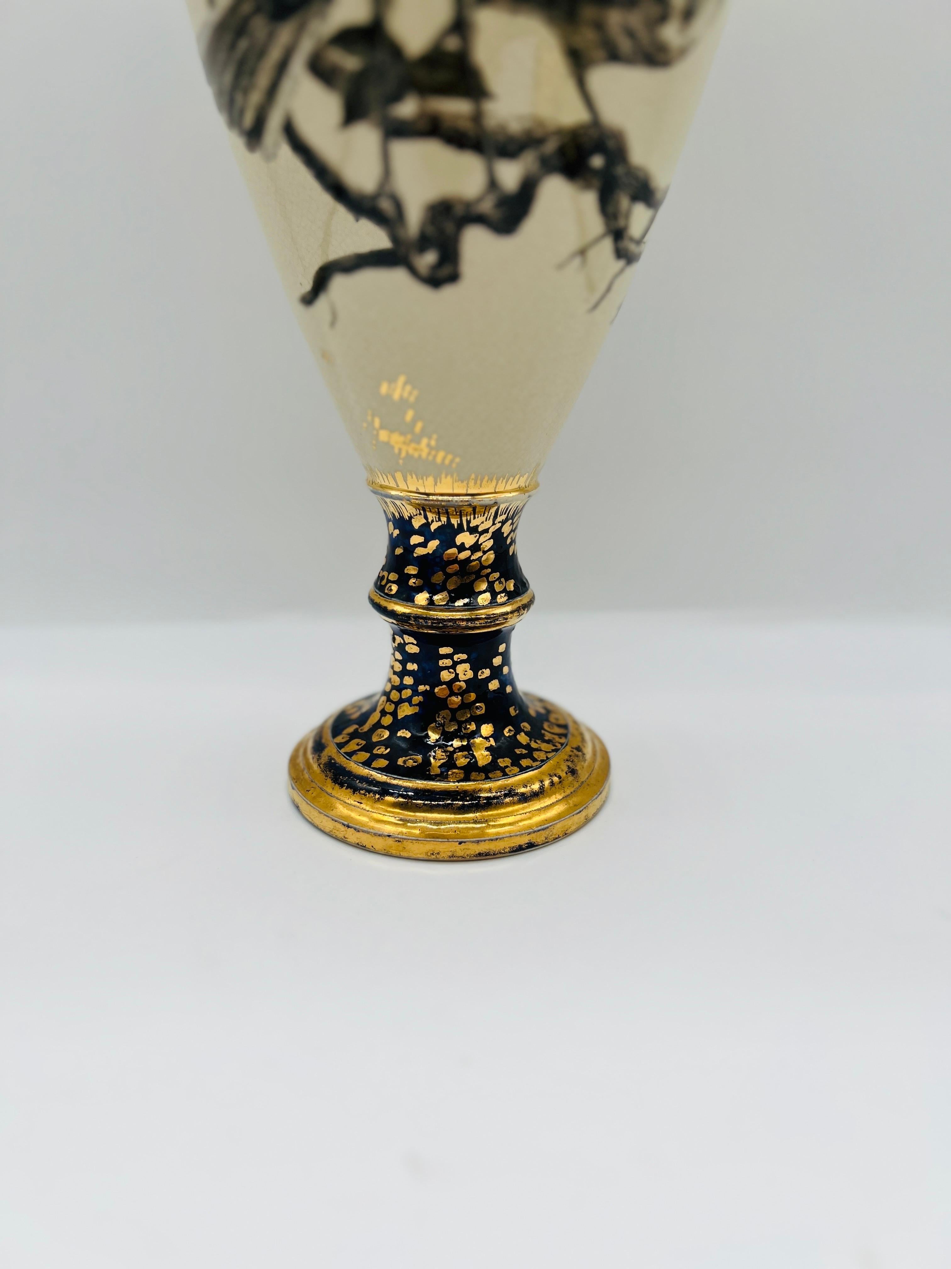Mrs. Fannie M Banks For Cincinnati Pottery Club (American, 19th century) Circa 1879.

An antique 19th century vase by Mrs. Fannie M Banks. The vase made of porcelain has cobalt detailing to base and stem with gilt detailing throughout. The main body
