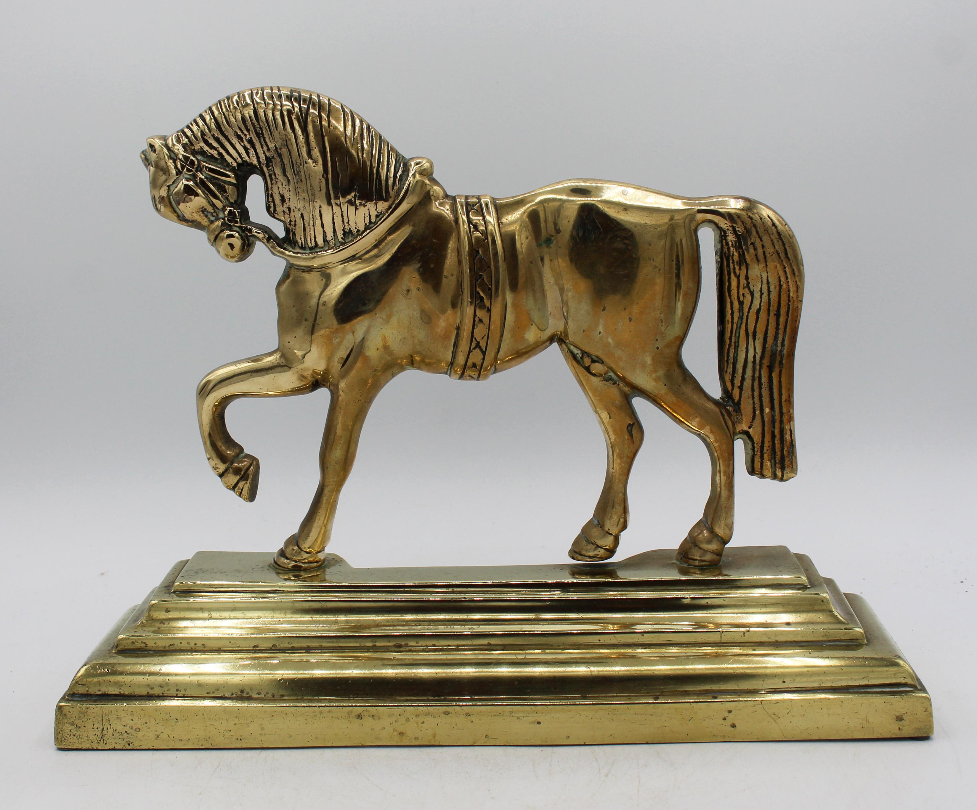 Circa 1880 pair of brass horse doorstops, English. Heavy & handsome - ideal as bookends or decorative accessories. Each horse with raised foot stepping out. Very fine cases. Stepped plinth bases.
12