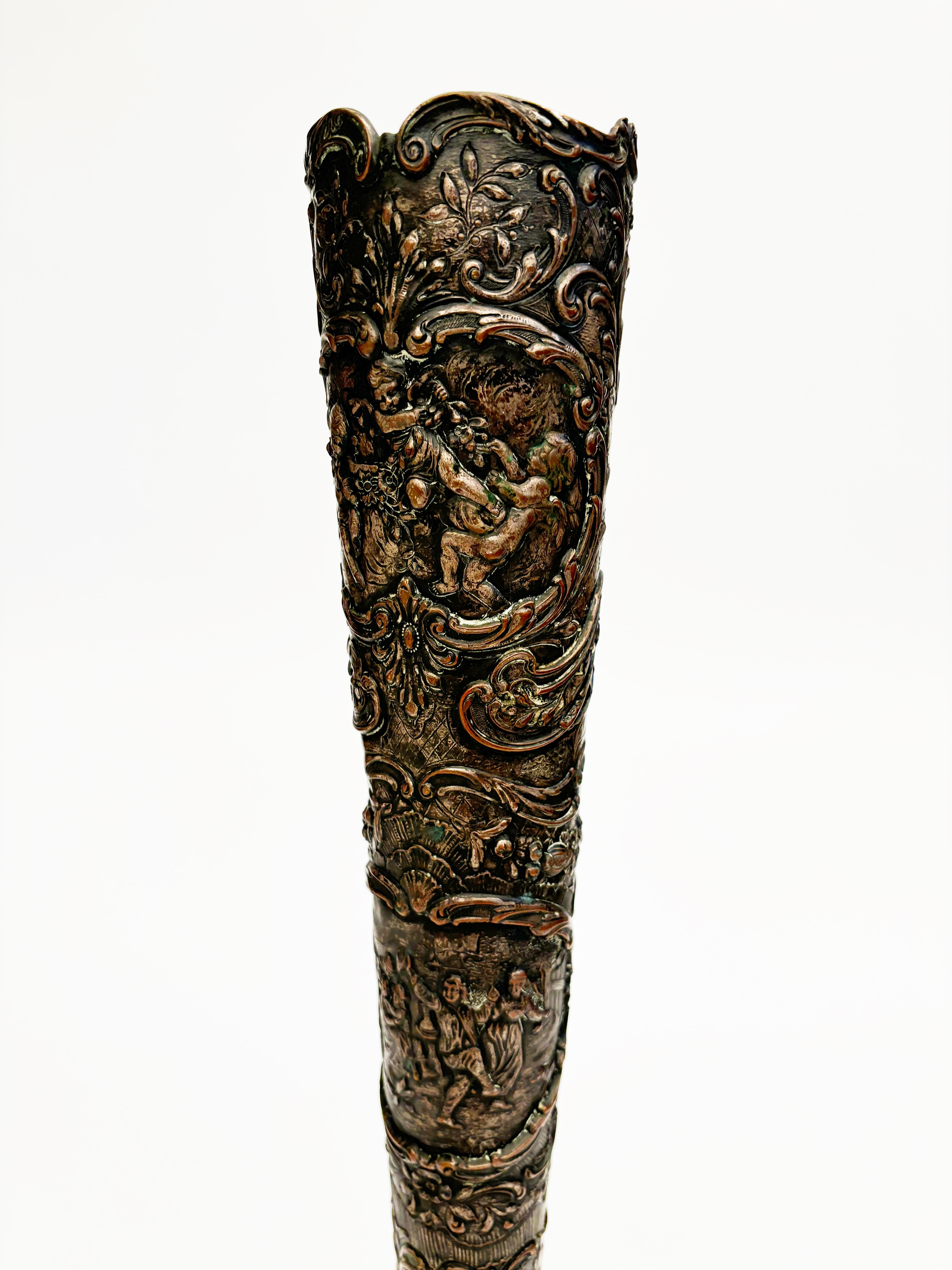 This trumpet vase has extraordinary repousse overall portraying festive moments with children and cherubs. This piece was created by E. G Webster & Son around the late 1890’s to 1900 in Brooklyn, New York. 

This beautiful piece has the most