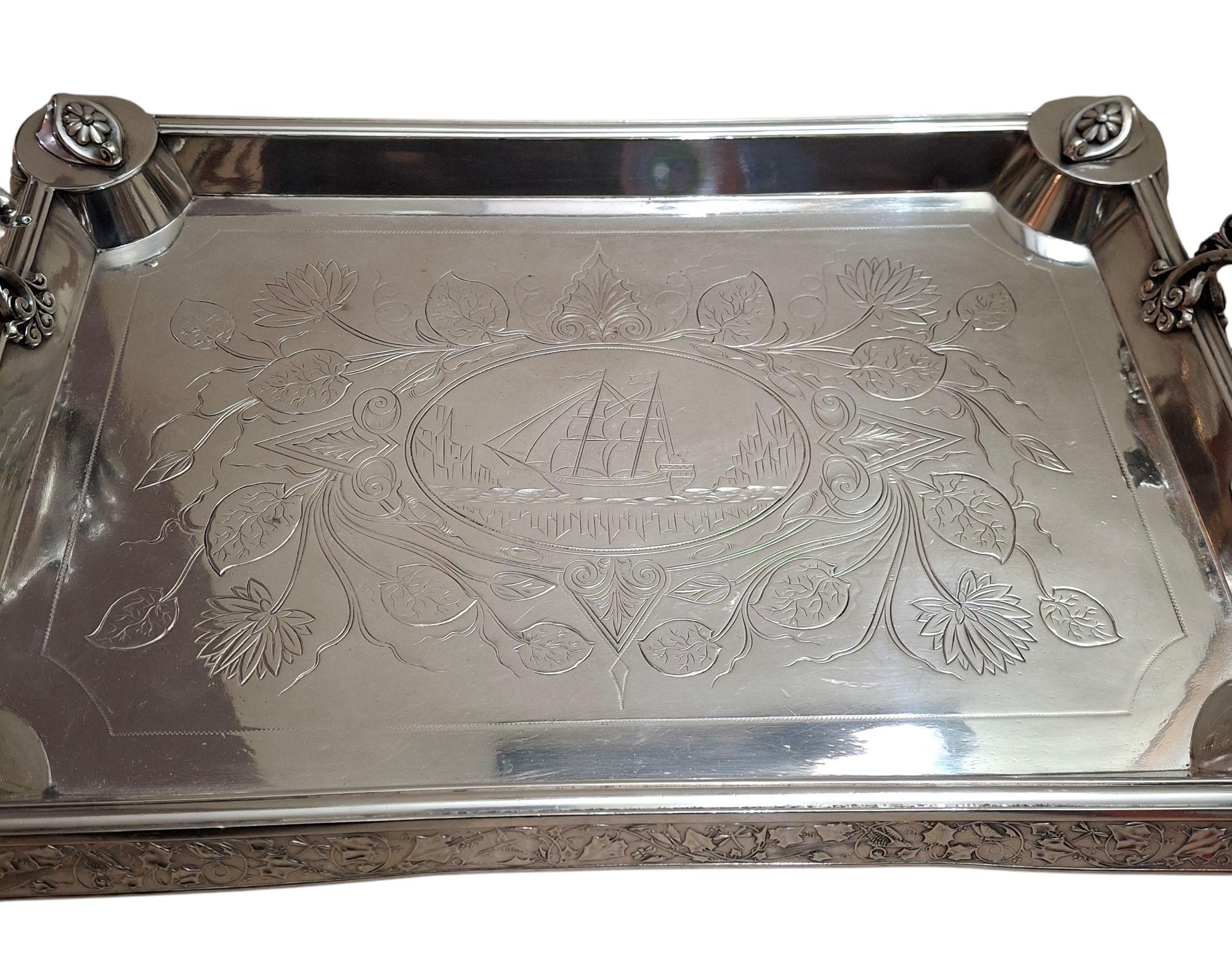 Stunning silverplate serving tray by Middletown Plate Co., circa 1890.  Decorated with an engraved clipper ship vignette, flanged sides with ornate foliage scrolling and figurative handles in the form of nude sirens.  Exceptionally well made and a