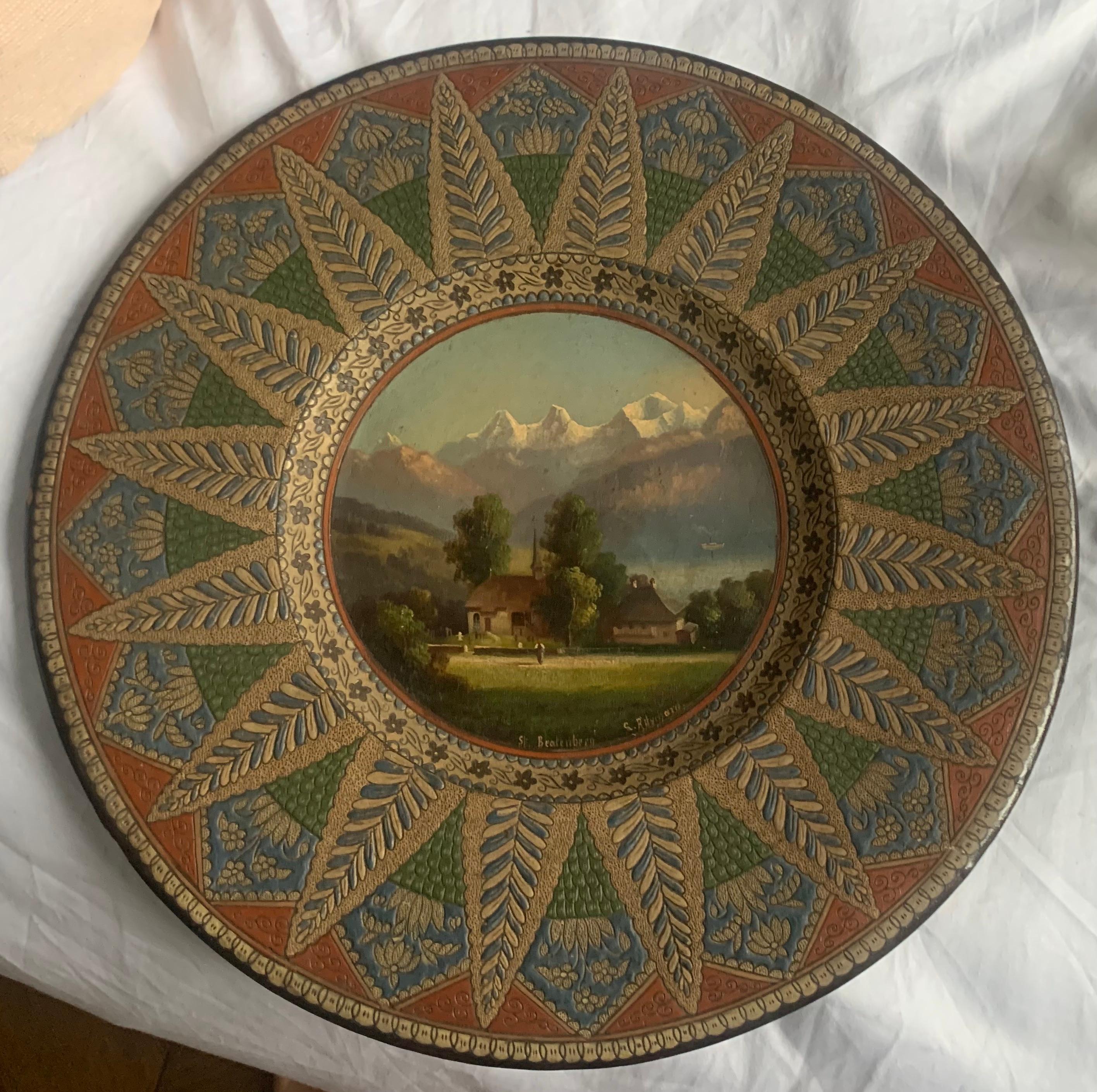 A circa 1890s, Swiss late 19th century, Thoune plate of St. Beatenburg and painted by Louis Ritschard (French 1817 - 1904). A beautifully painted, in miniature, of a lakeside scenery with a small boat on the lake. The picture is surrounded by an