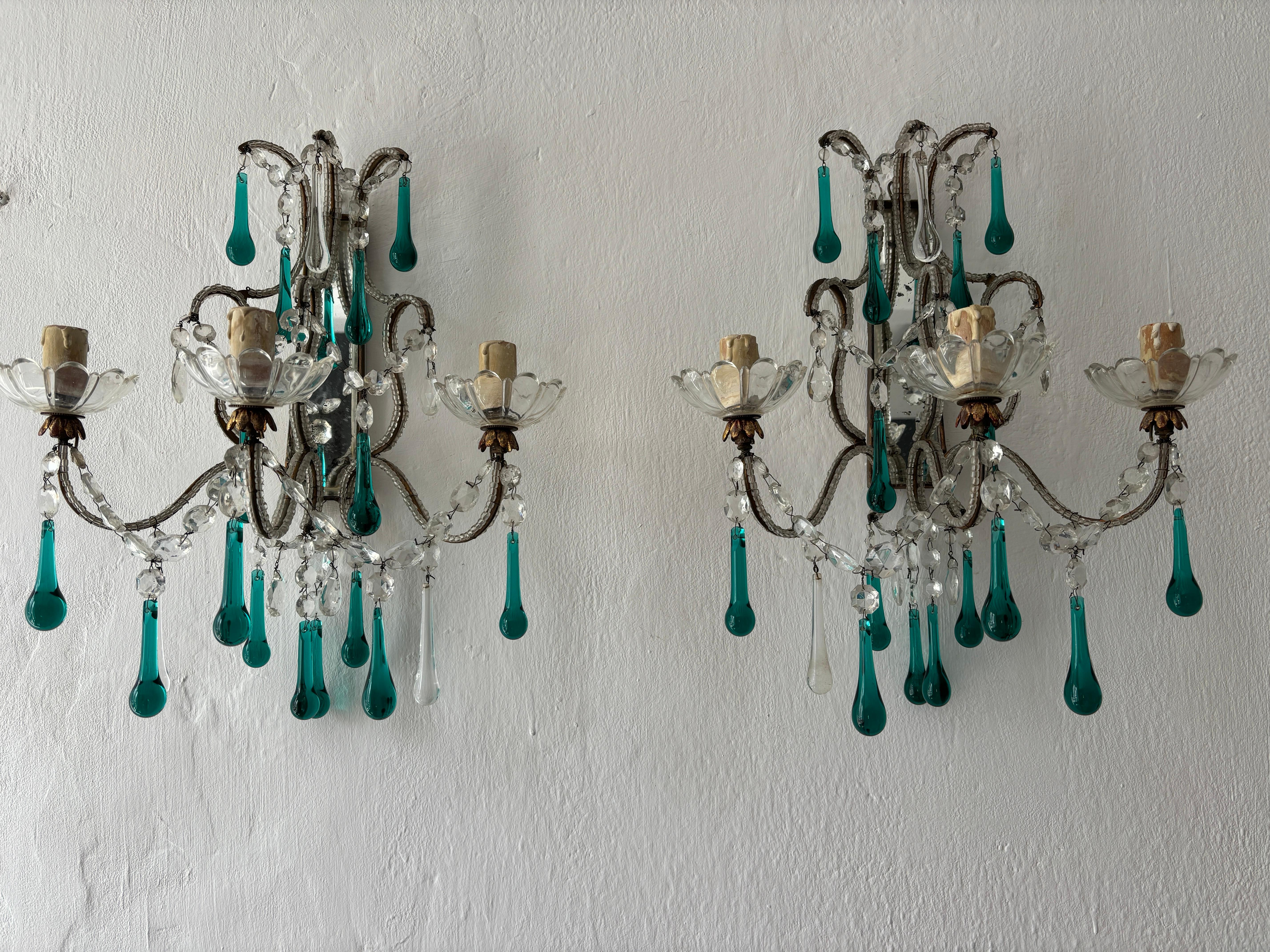 Housing a rare 3 lights each, sitting in crystal bobeches.  One of a kind sconces!  Completely beaded.  Swags of crystals throughout.  Each adorning extremely rare sea foam green Murano drops and clear as well. I have seen many green, but never this