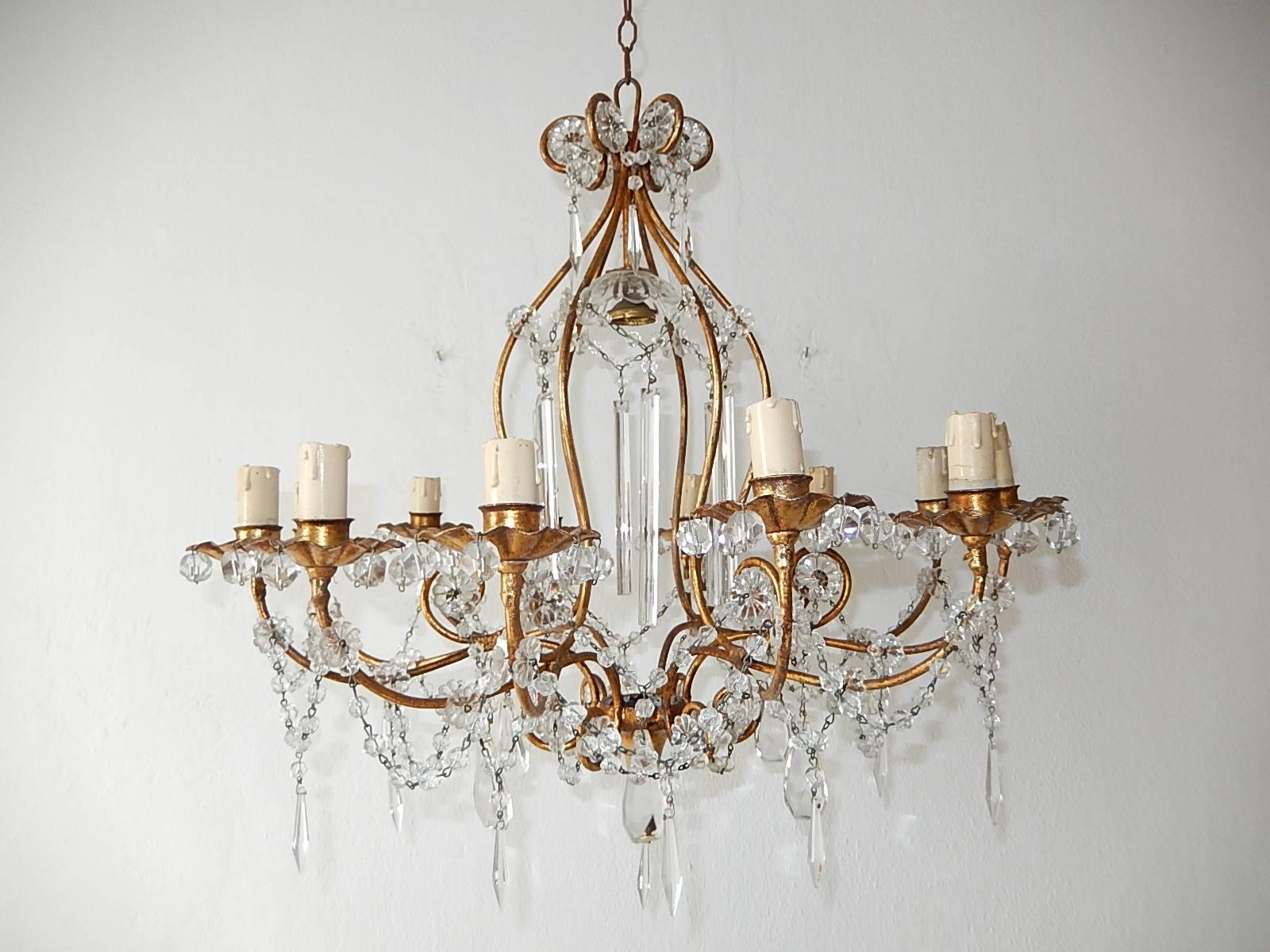Housing 13 lights. 12 encircling and one under a crystal bobeches. Rewired and ready to hang. Gilt metal with florets, swags of crystal beads and rare crystal prisms. Free priority shipping from Italy.