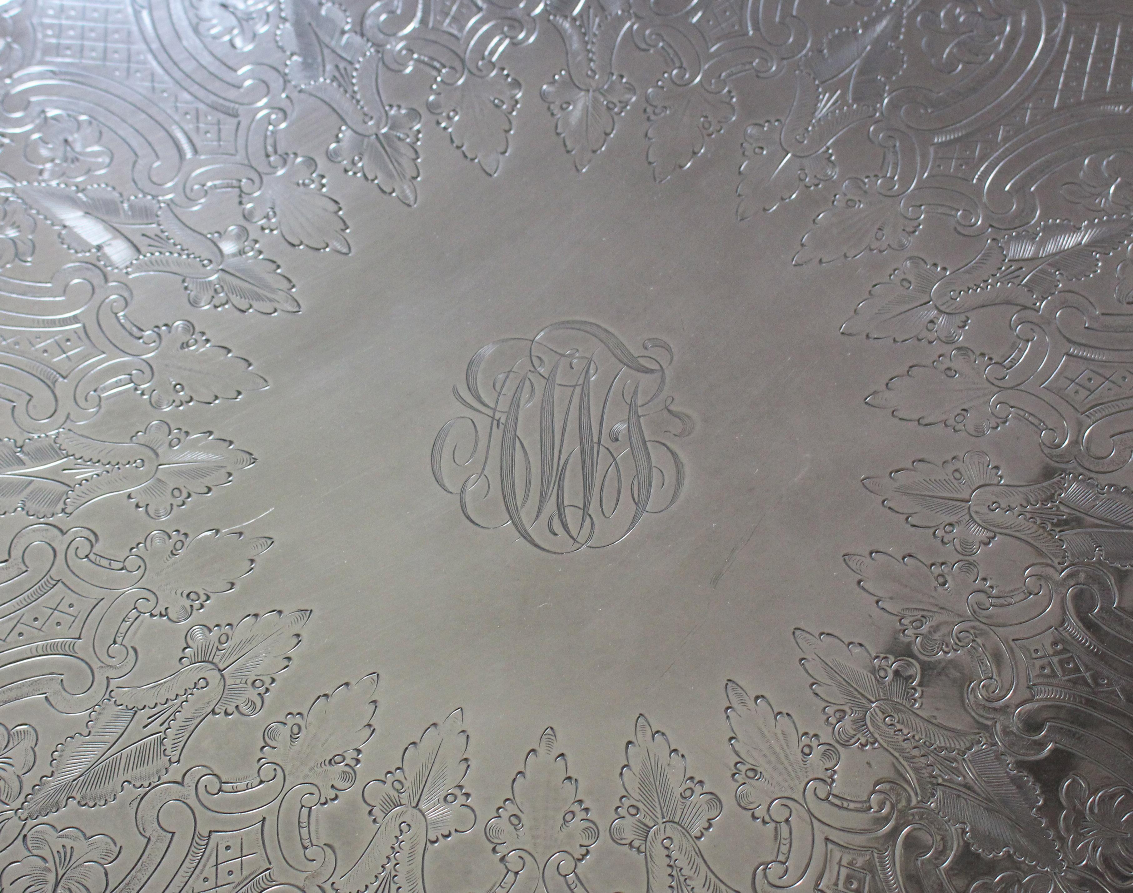 Electroplated salver, circa 1920, made in London by S.B. & Co. Electroplated nickle silver marks. Marked Made in England. Fine condition - the border design repeated in the vine & grape feet. Period monogram.
22 1/2