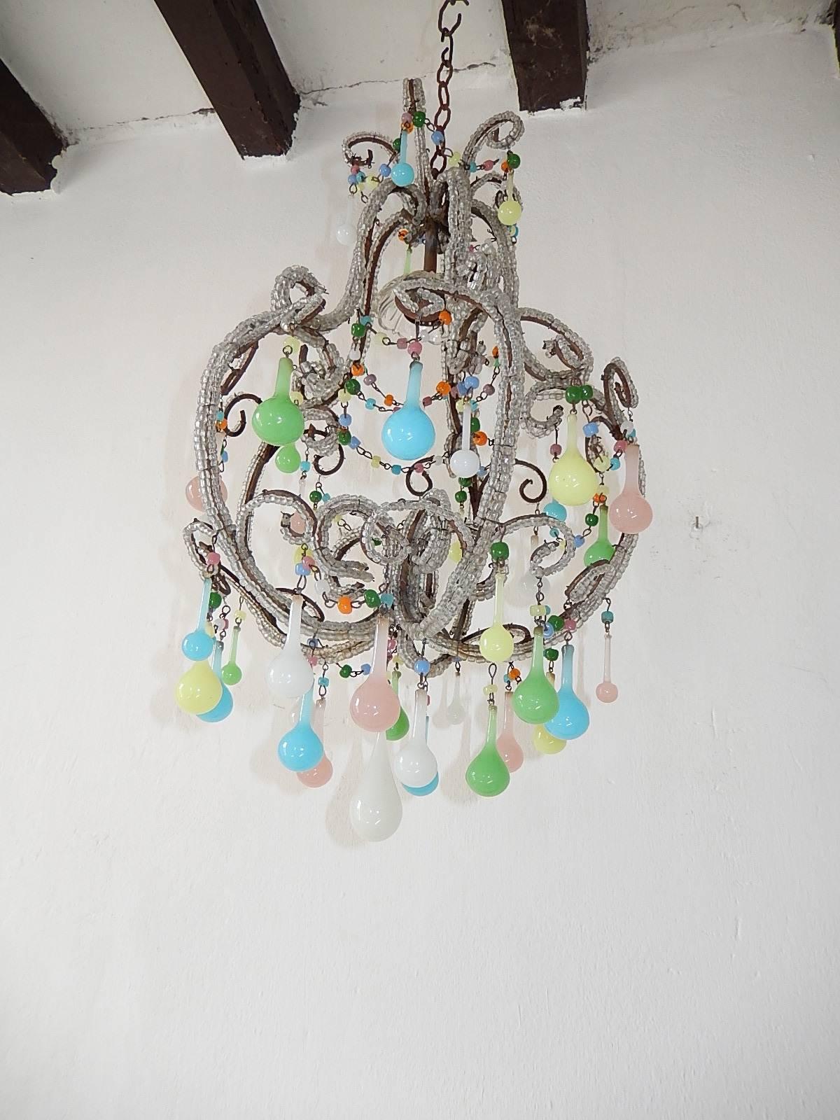 Housing one light under a crystal bobeche. Triple beaded throughout. Adorning swags of opaline beads and opaline drops in the colors of green, pink, blue, purple, white and yellow. Re-wired and ready to hang.