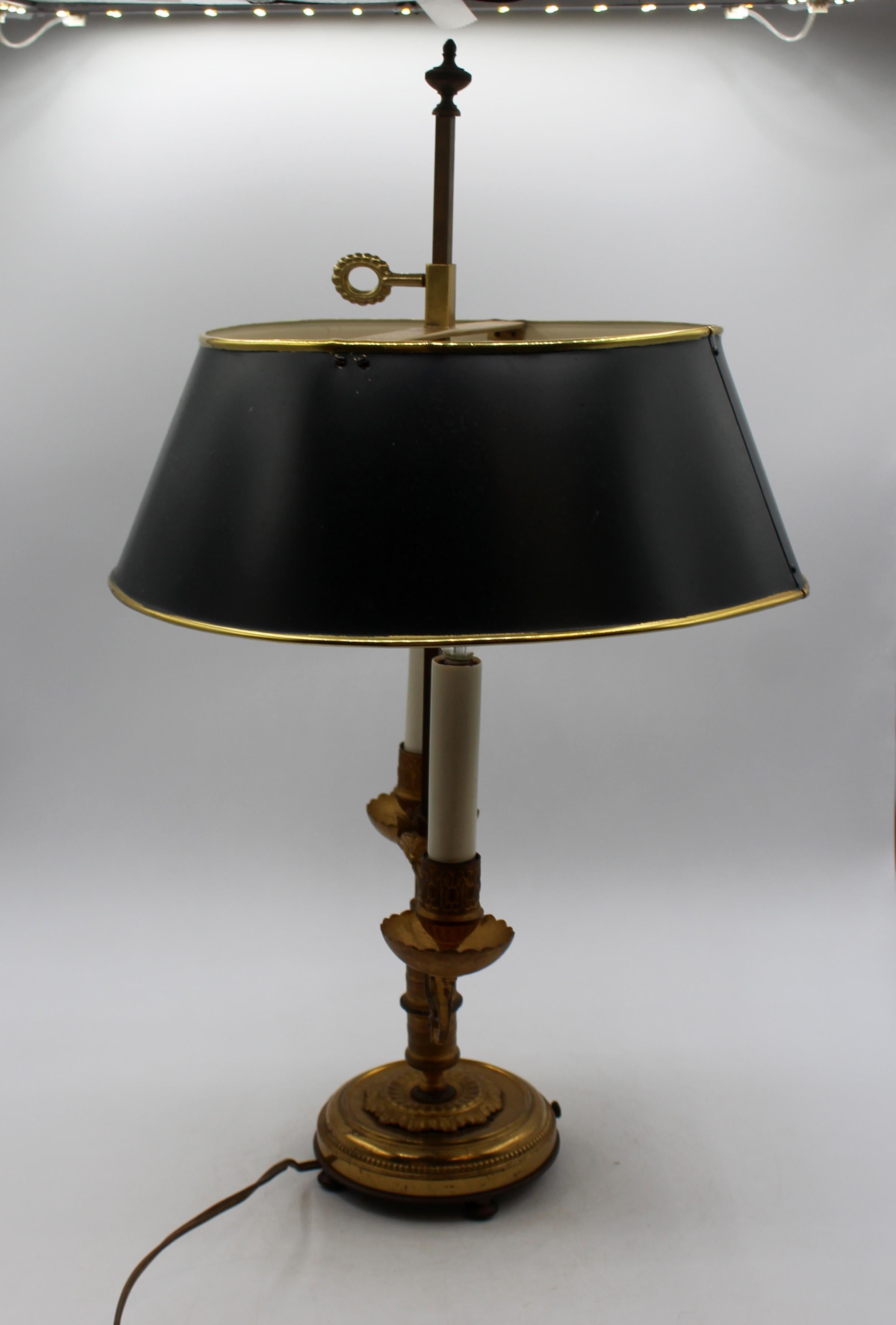 Circa 1920s gilt bronze & brushed bronze bouillotte lamp, French. Double light. French wired. Touches of Egyptian Revival in the decoration - stylized acanthus & other motifs. Shaped bowl bobeche. Turned feet. 12.25