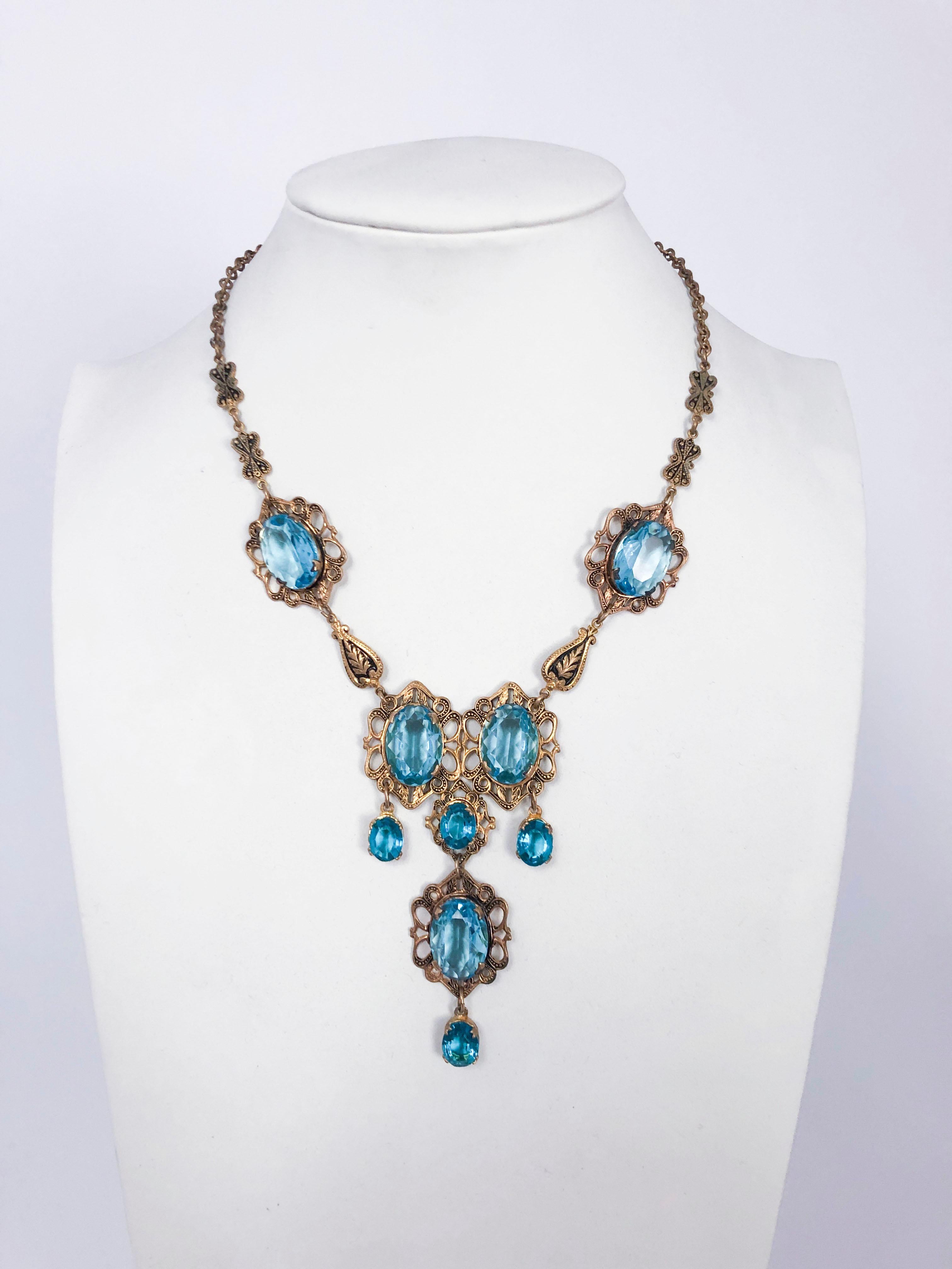 Aqua and brass necklace with large stones, intricate fastenings, and matching drop earrings with modern fish hook backs.