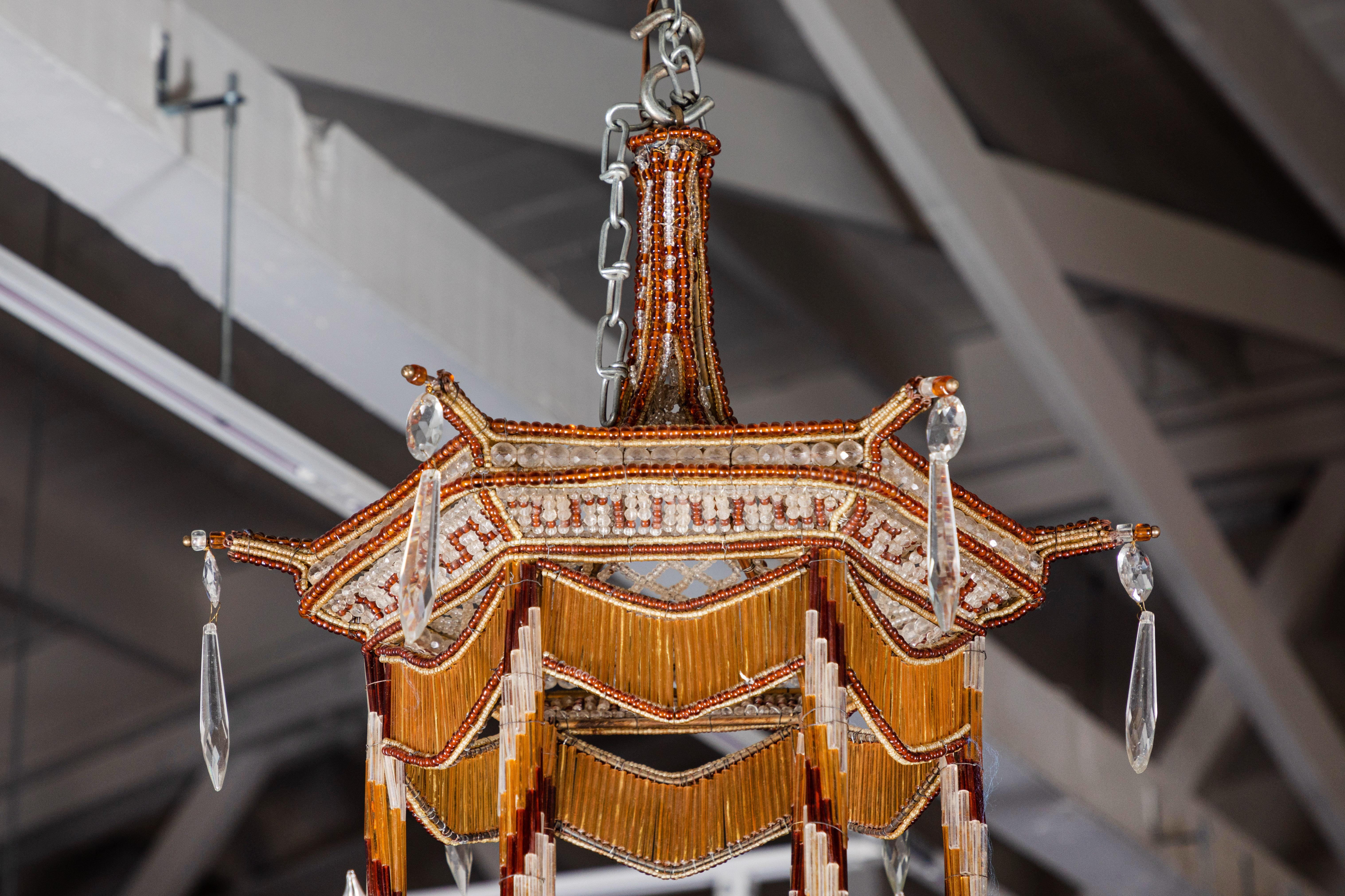 Striking, hand-beaded, six-arm, Sicilian pagoda-style chandelier trimmed in gold and crimson. The pierced basket is matched by an upper body dish of the same, with the latter embellished by faux draper swags.