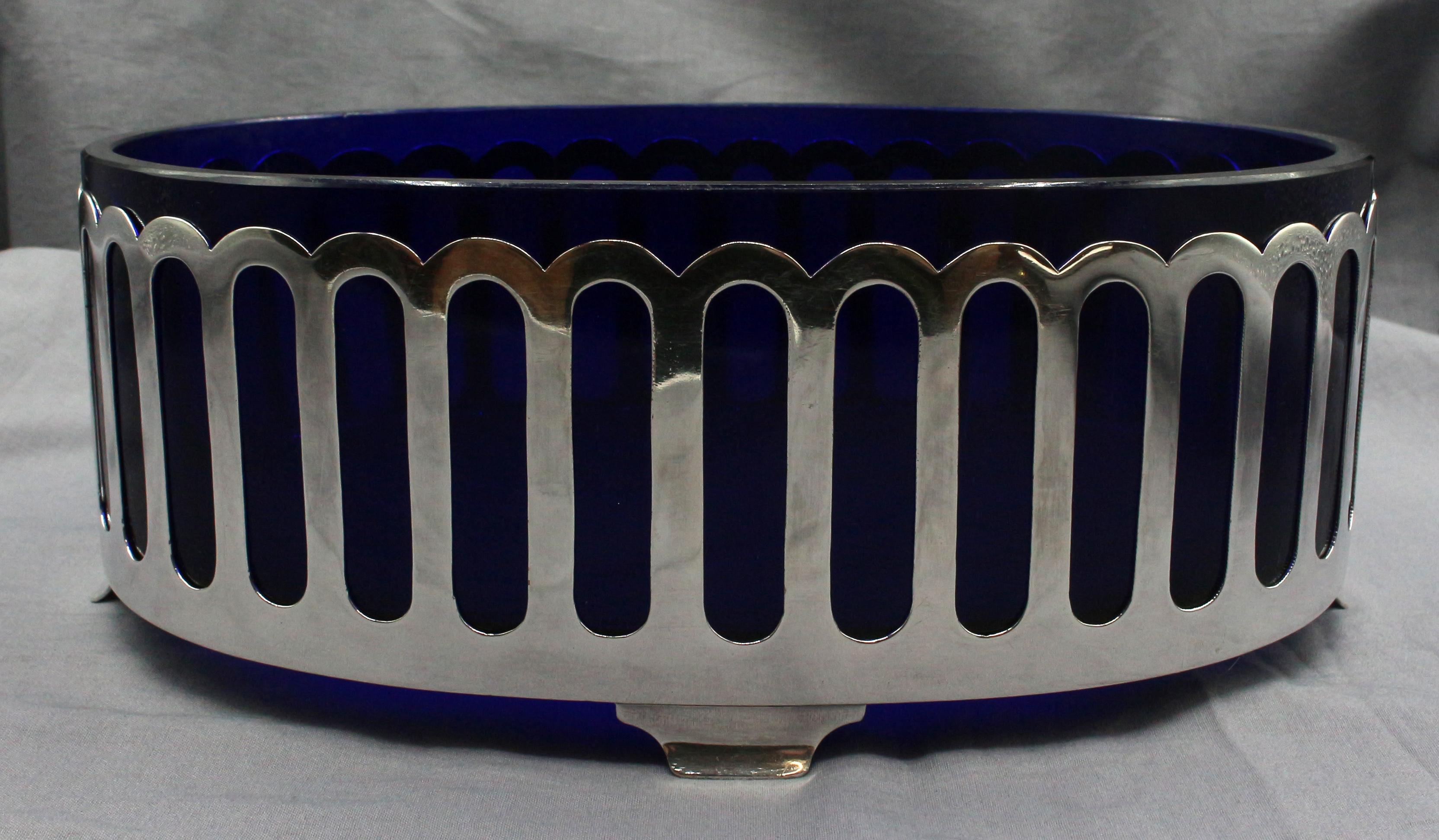 Art Deco circa 1930s cobalt glass & silver plated oval serving dish or centerpiece. Very stylish, the cobalt blue glass striking against the cut-work silver plate. Interior of the bowl with scratches from use over nearly 100 years.
10.75