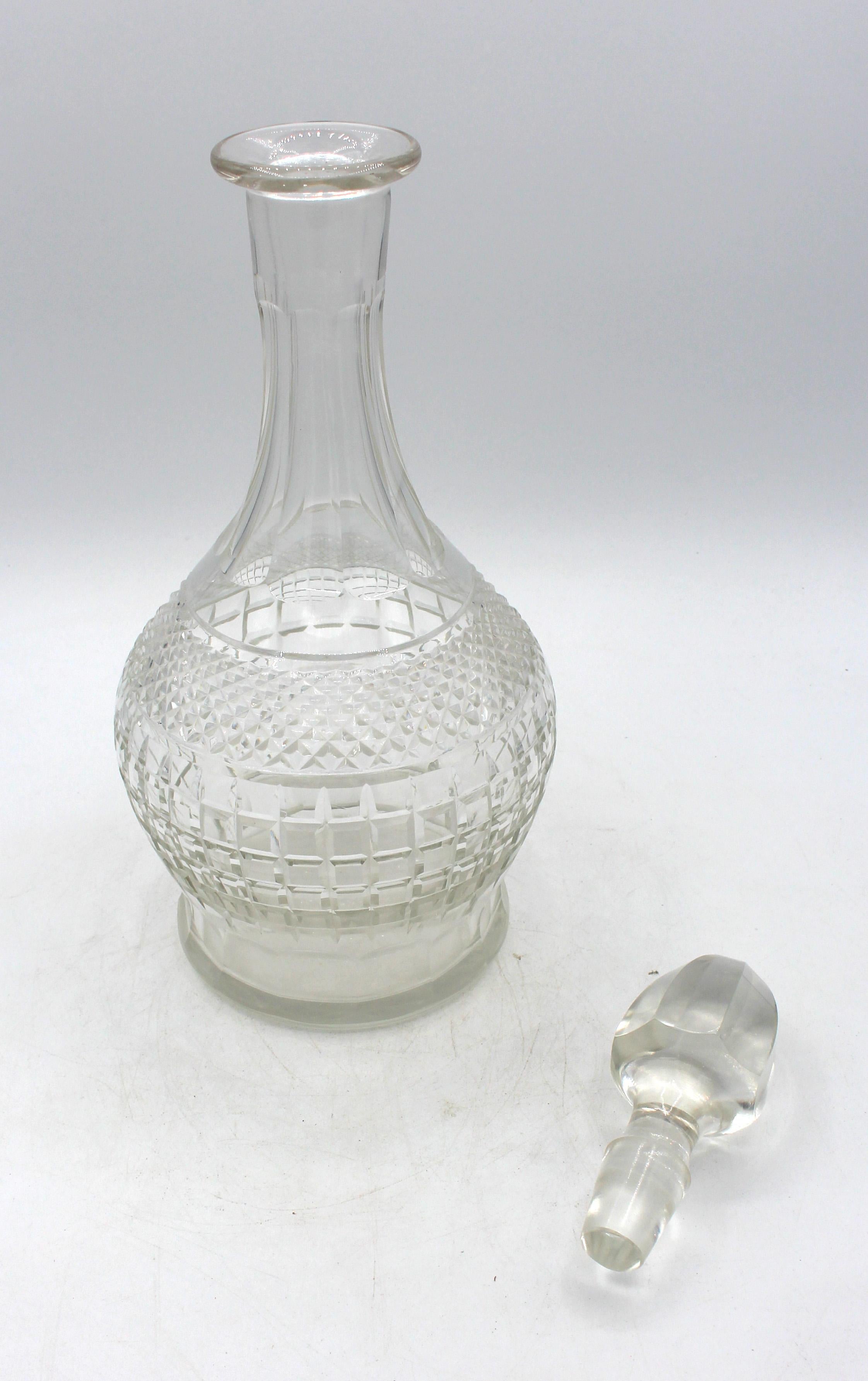 Circa 1930s pair of Continental glass decanters with stoppers. A splendid pair bought in Milan in the 1930s for a wedding gift. The square panels below a band of cut diamonds add dimension. Panel cut necks. Original panel, tapered stoppers. Touch of