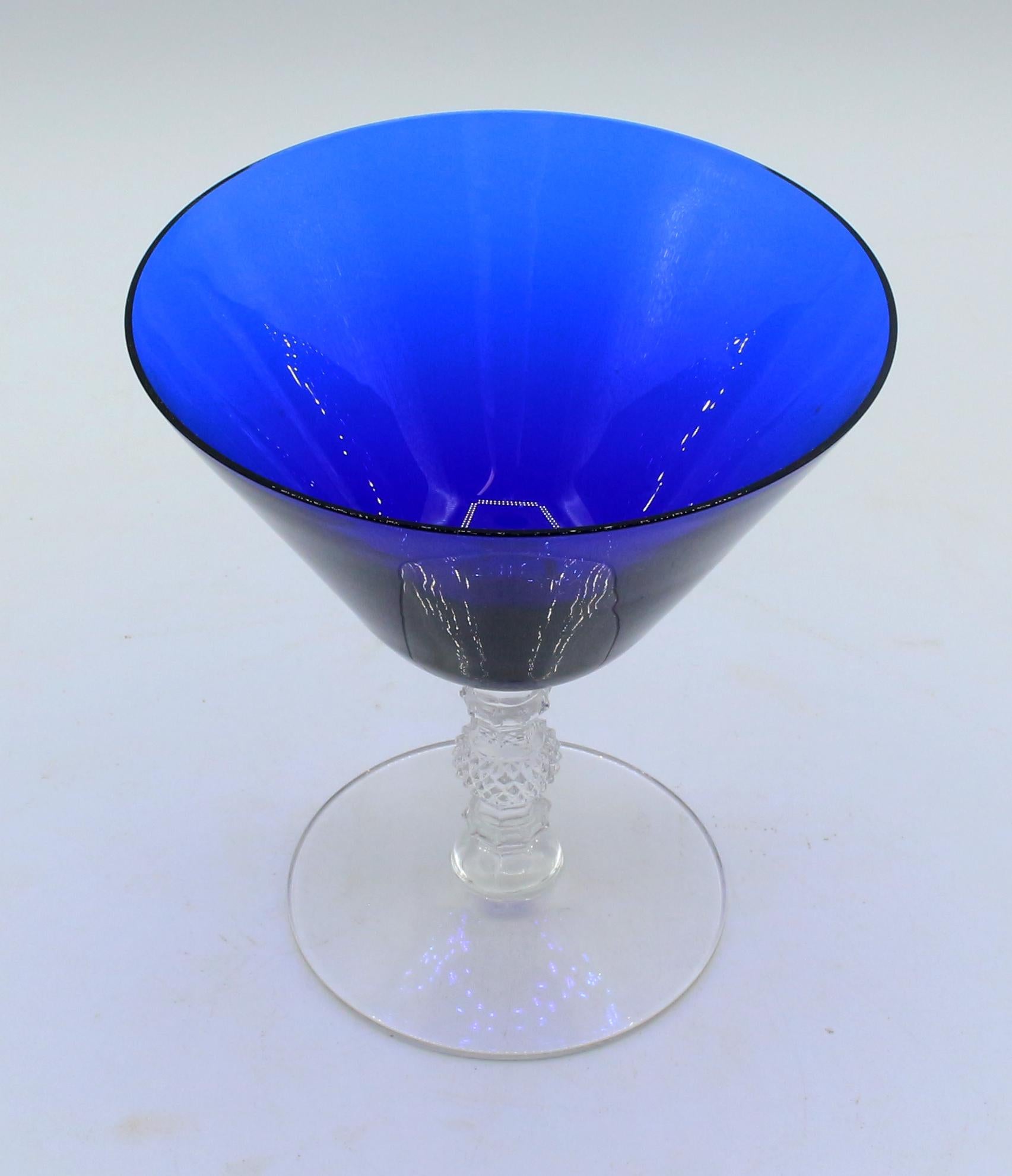 A set of 12 +1 sherbets or champagnes by Cambridge Glass Co., Ohio, c.1930s. Cobalt Blue bowls with faceted, molded clear glass stems & bases. Pattern 3122, rarely found. 
4 5/8