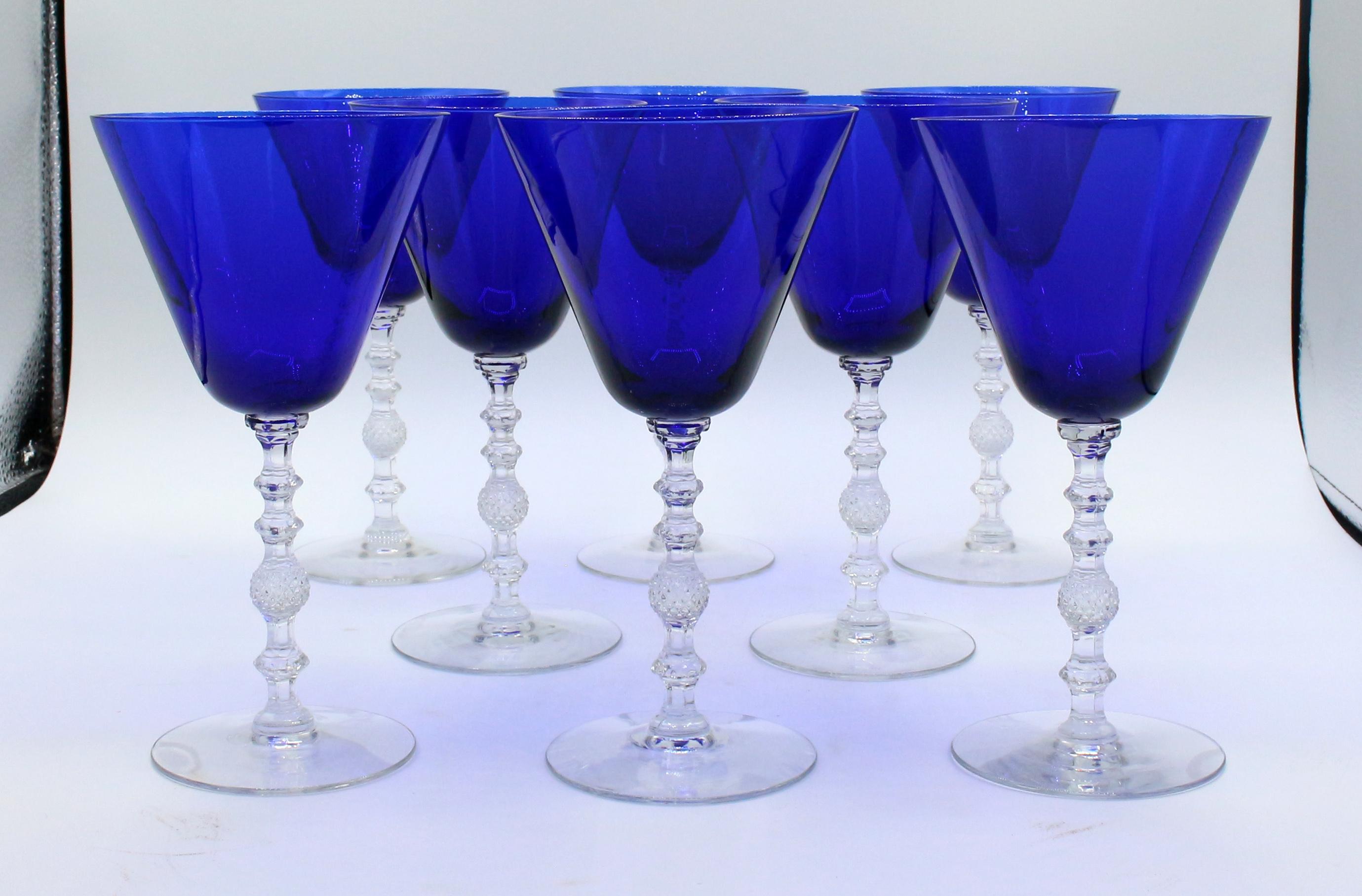 A set of 8 water or large wine goblets by Cambridge Glass Co., Ohio, c.1930s. Cobalt Blue bowls with faceted, molded clear glass stems & bases. Pattern 3122, rarely found.
7