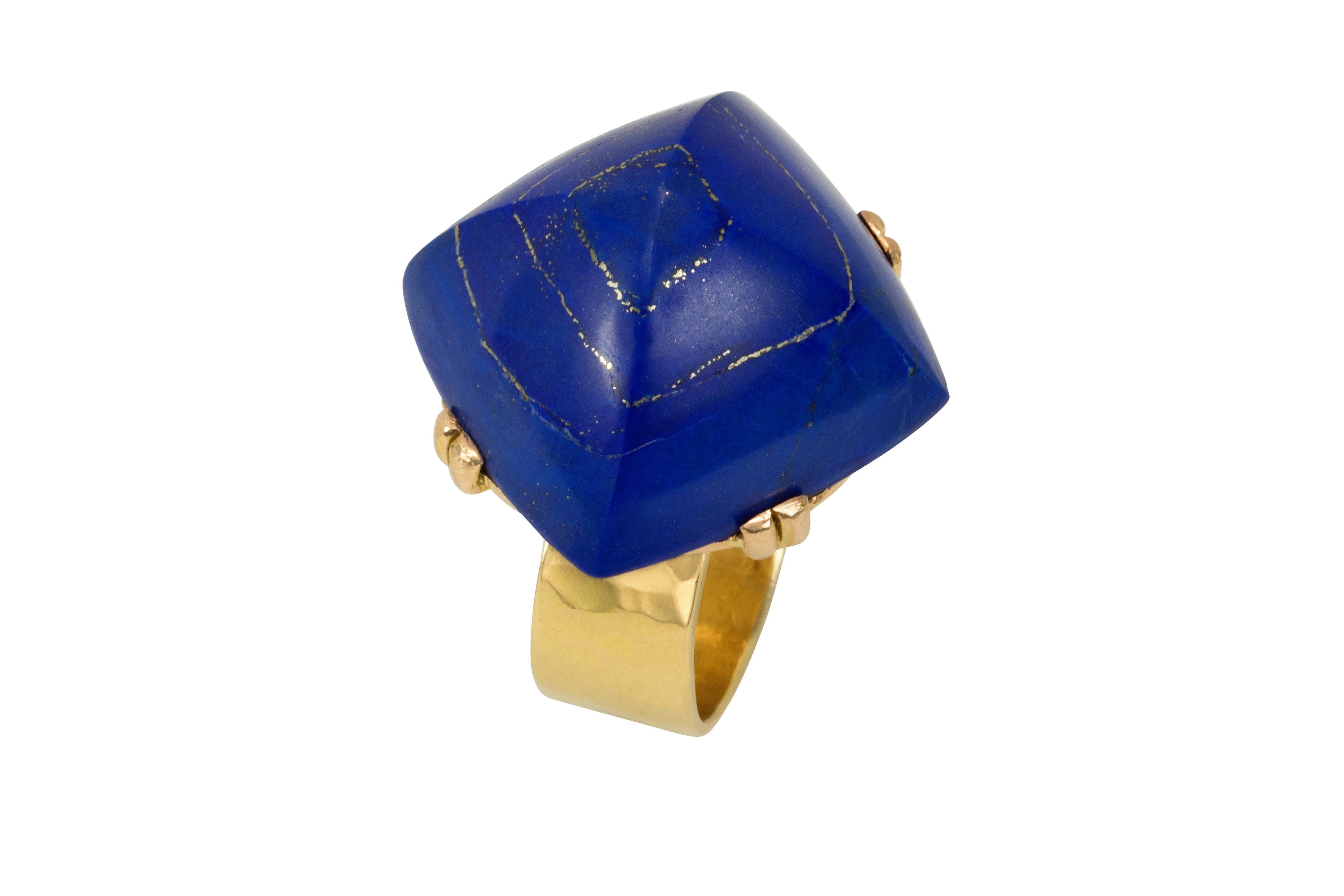 This exceptional Jean Despres ring in 18 karat planished gold features a high-rise sugarloaf cabochon lapis lazuli resting on decorative gold beadwork. It was made in c. 1940 and is stamped with the maker’s mark and French assay marks. 

Després