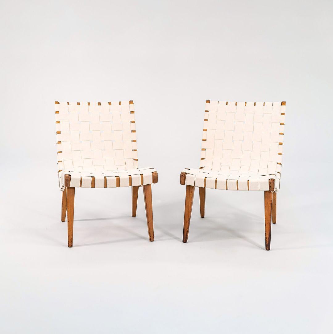 This is a pair of Risom Lounge chairs, Model 654LC, designed by Jens Risom for Knoll in 1943. These are early examples, dating to C. 1946. The listed price includes the pair. Their classic design features a sculpted lacquered birch frame and has