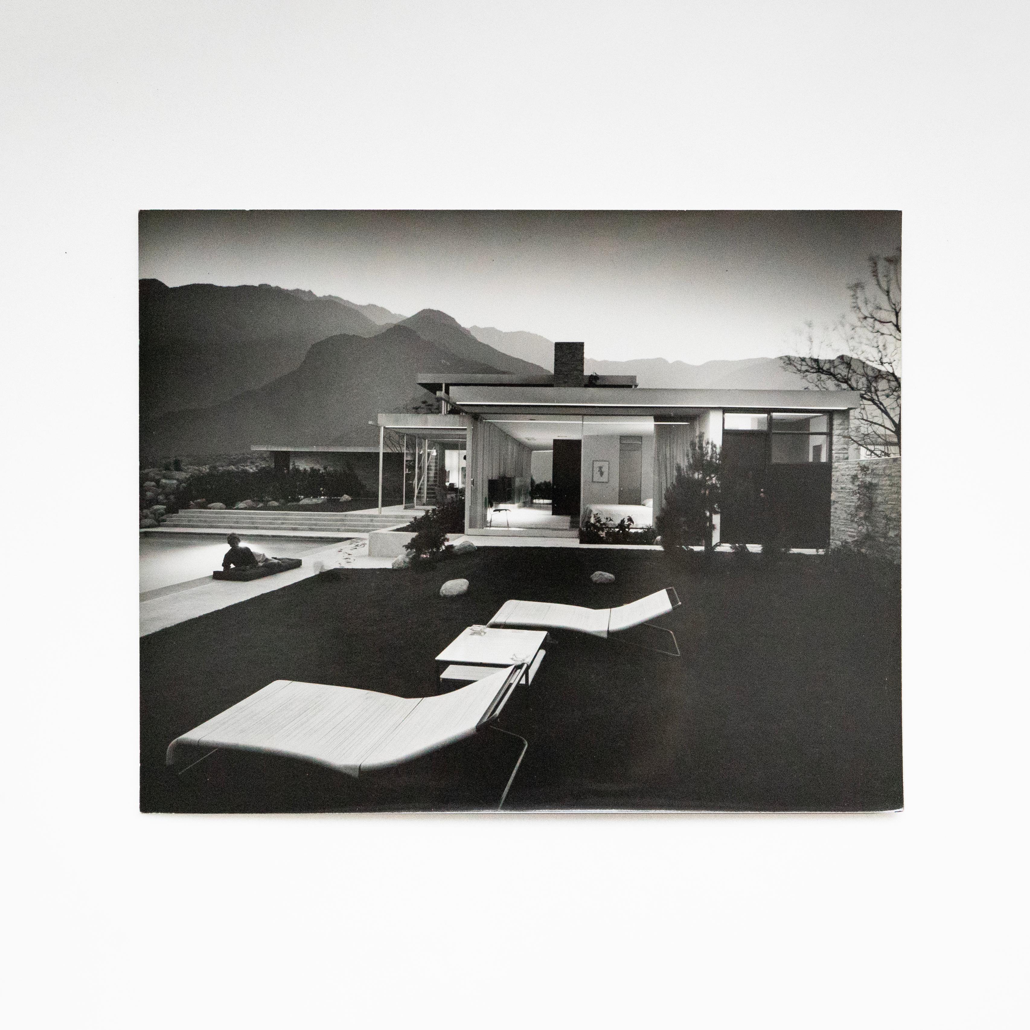 This is Julius Shulman's iconic photograph of the Kaufmann House, designed by Richard Neutra in 1946 and photographed by Shulman in 1947. The house was commissioned by Edgar J. Kaufmann, Sr. who also commissioned Frank Lloyd Wright's Fallingwater.