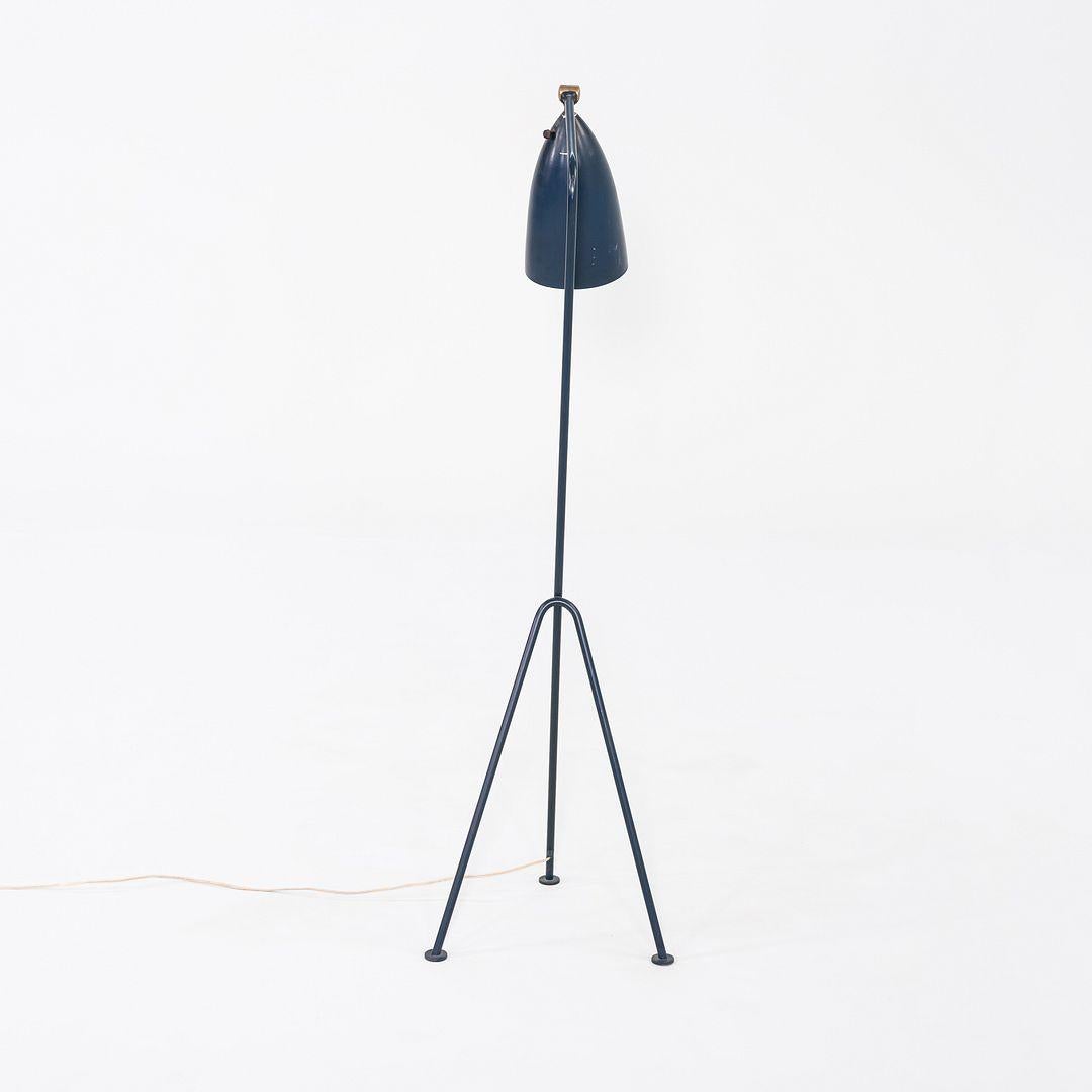 This is an original Grasshopper Floor Lamp, initially designed by Greta Magnusson Grossman for Bergborn in 1947. This example was produced in Sweden ca. 1948. The lamp retains its original blue paint, and functions properly. It has a tubular steel