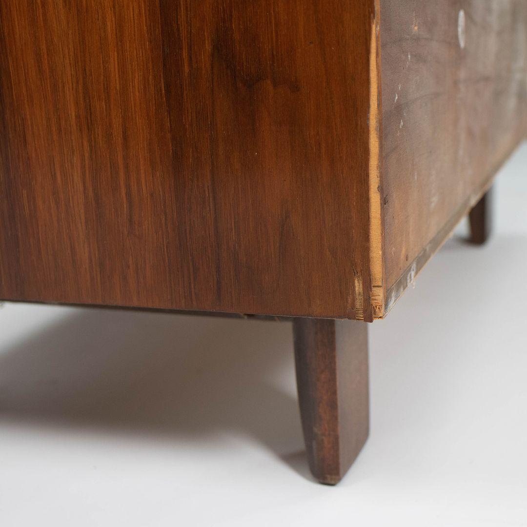 This is a George Nelson for Herman Miller Basic Series Secretary Chest, circa 1955. The Basic Cabinet Series, or BCS, was a collection of wood storage solutions developed by Nelson in 1945. This example is done in walnut and has a drop-down front