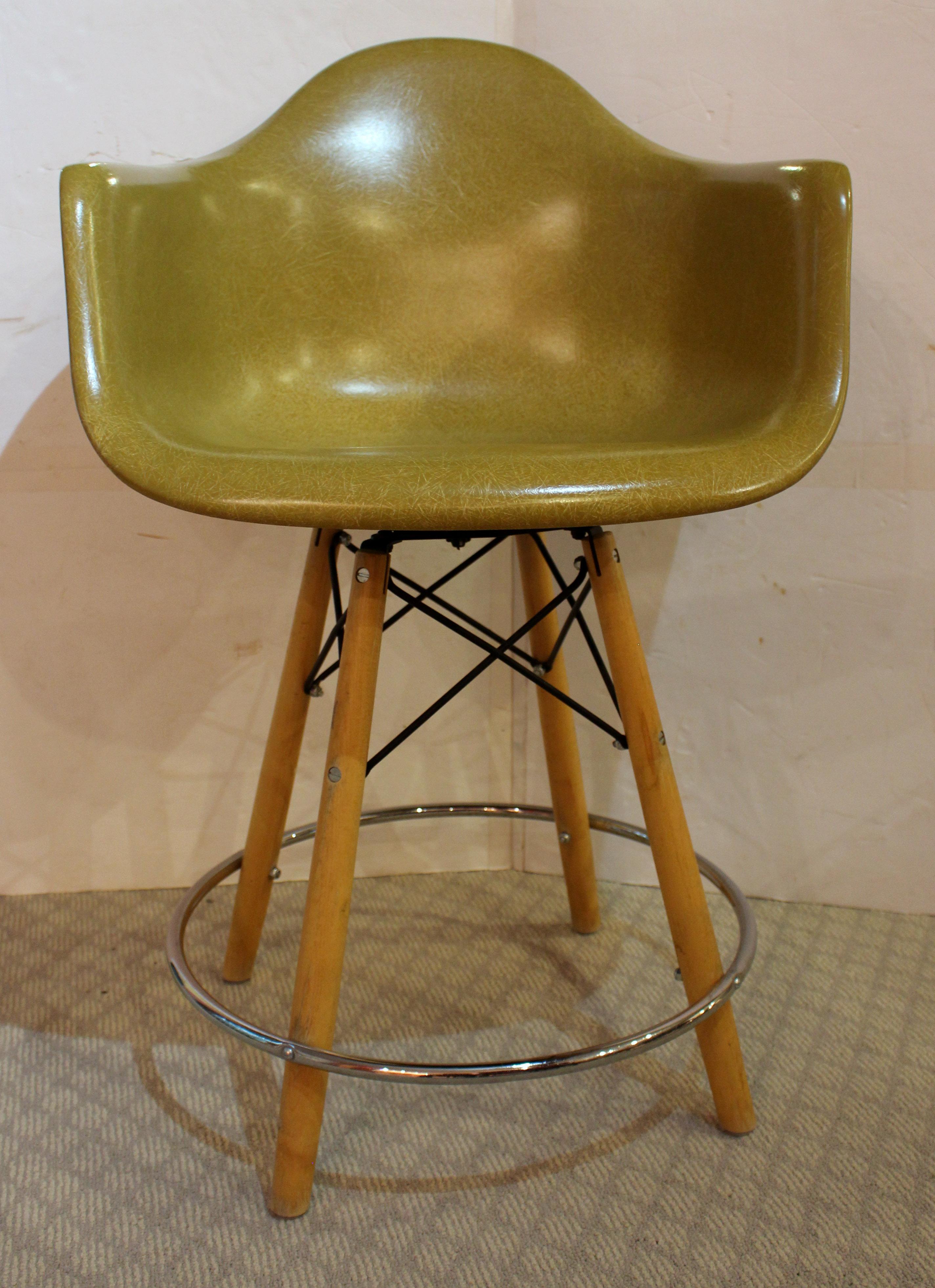 Circa 1960 bar stool by Charles Eames for Herman Miller. The molded fiberglass shell seat is the same they used for chairs, large & comfortable. The base is of birch & blackened steel 