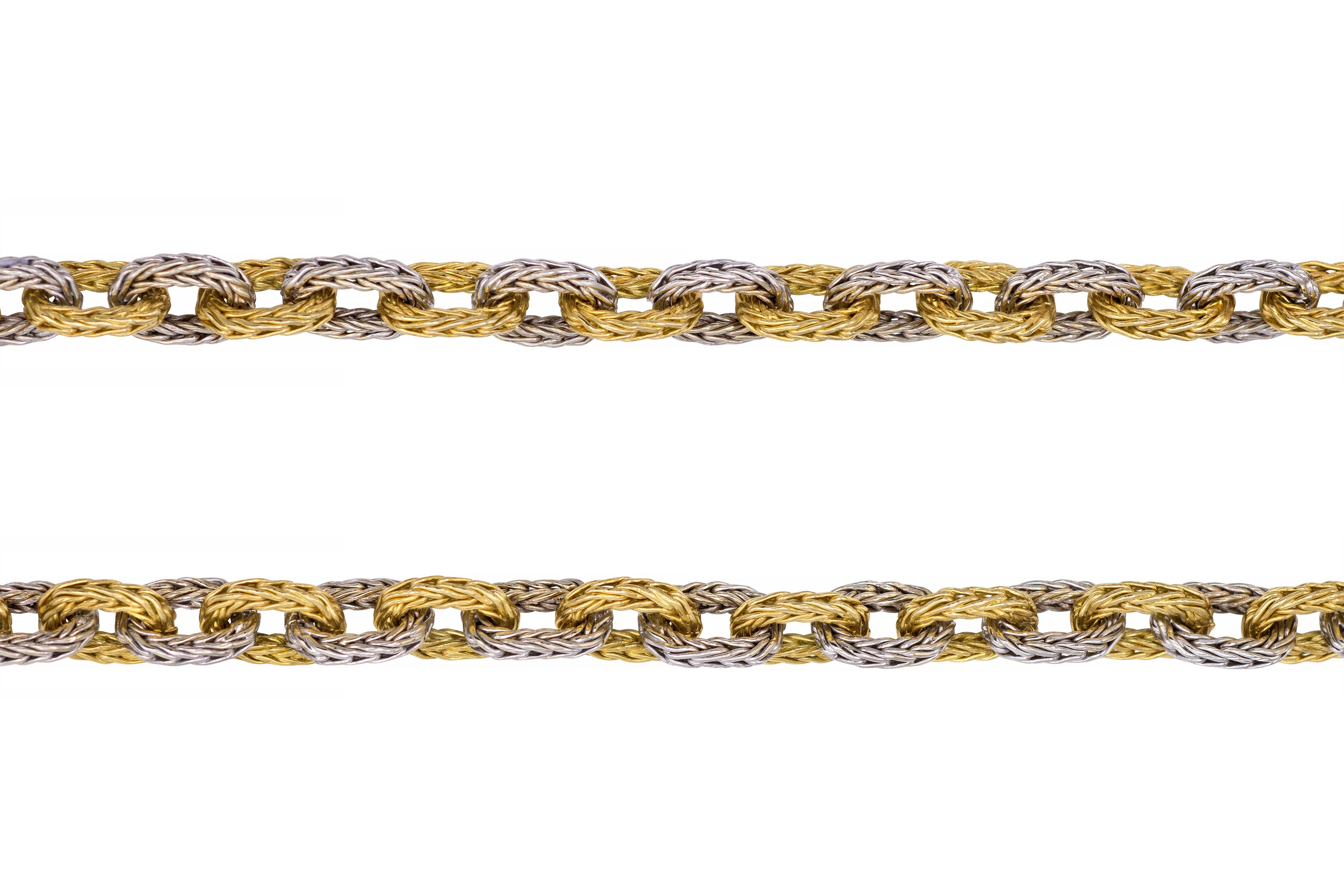 A substantial, vintage 18 karat white and yellow gold braided link chain, Italian, c. 1960. This hand-crafted suburb necklace weighs 156 plus grams. Stamped 750 with Viterbo Registered Trade Number. 

A stunning piece of jewelry that makes a