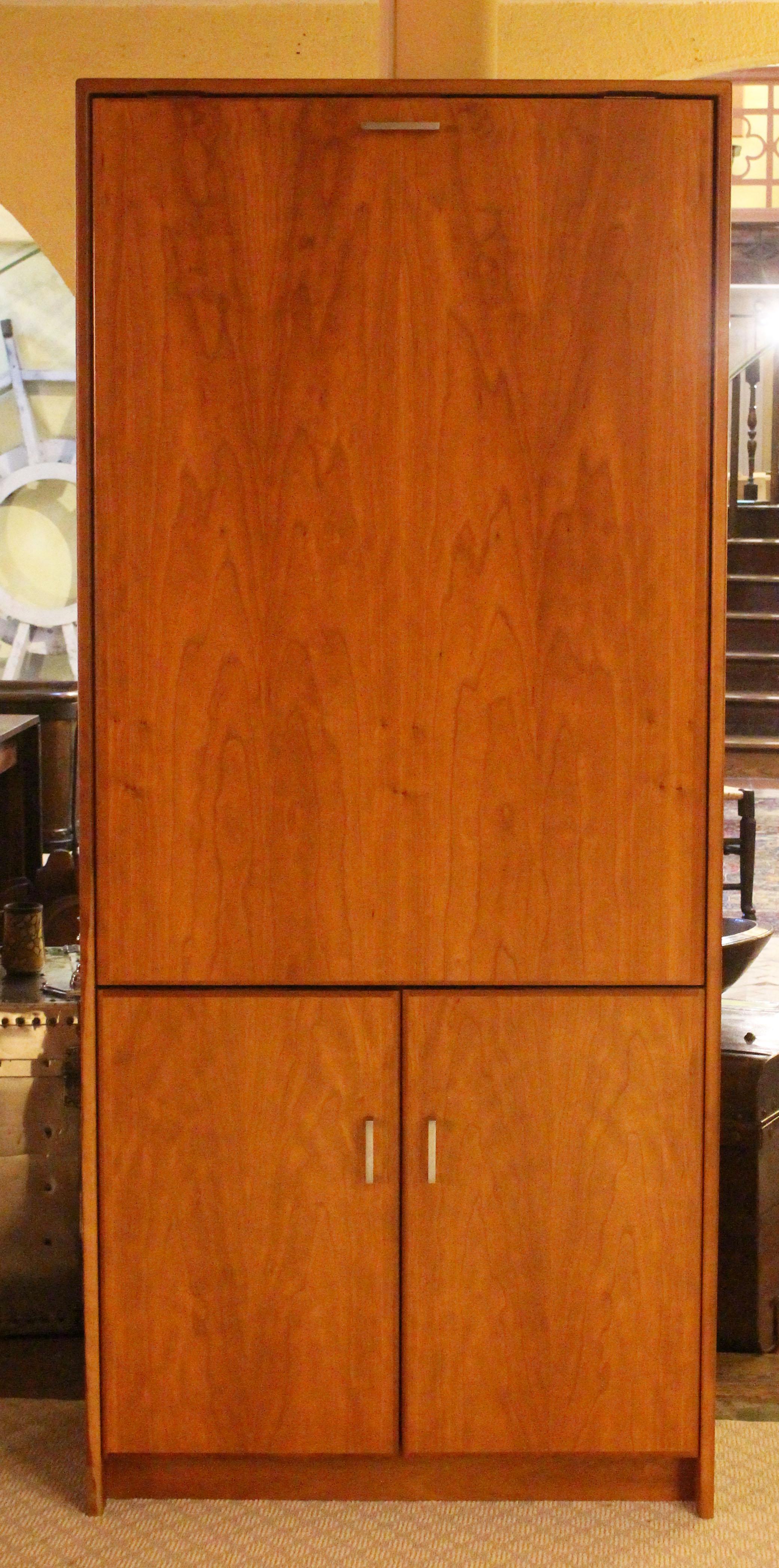 A Danish mid century modern cabinet with fold-out table, c.1960s-70s. Cherry with heartwood. Lovely figure to the doors. The upper single door opens to reveal a fold-out table and three interior 14 3/8