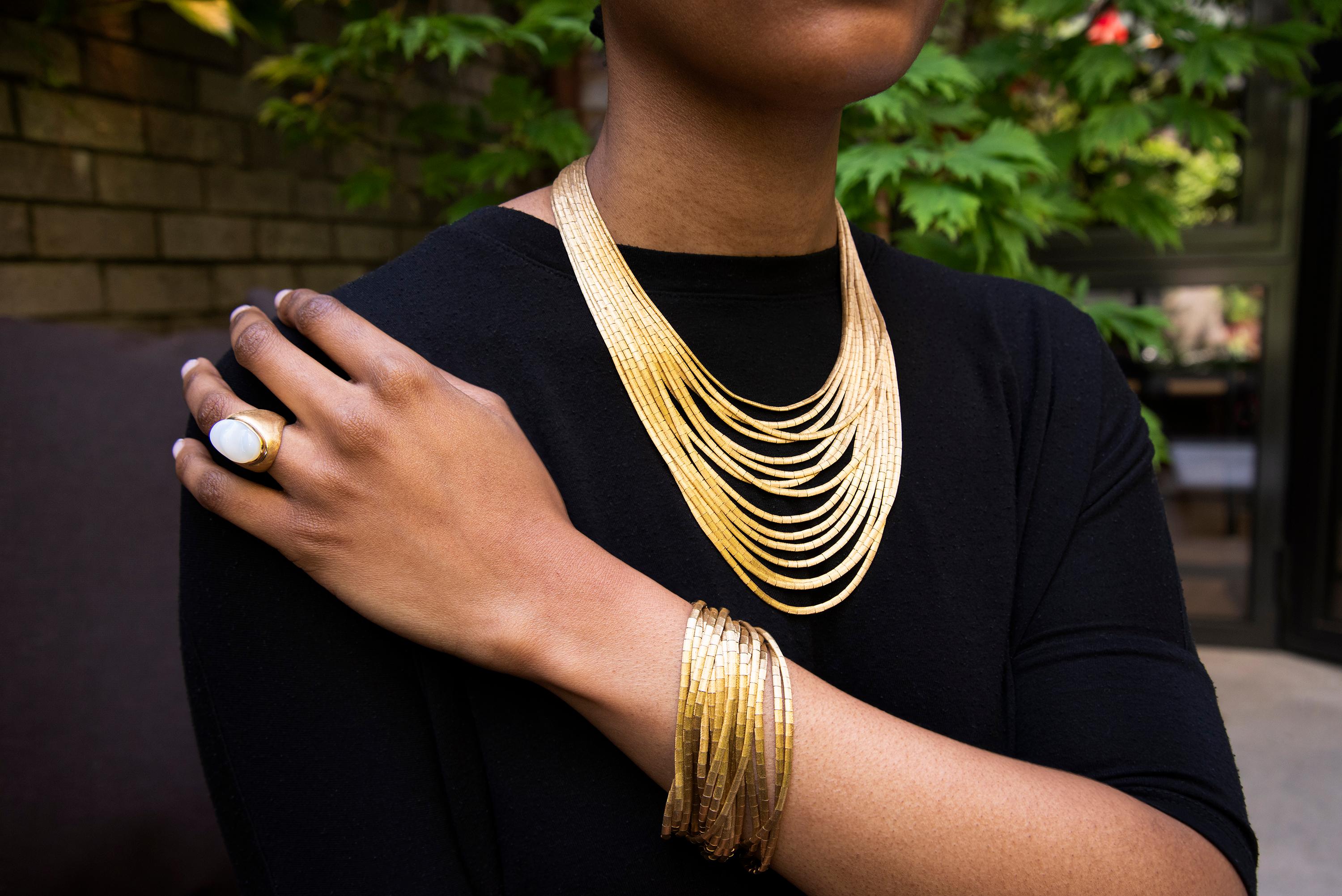 An especially swinging, multi-strand 18 karat brushed gold, 15-strand necklace, Italian c. 1960s. Stamped with maker's mark and 750. 
The longest strand measures 21.0