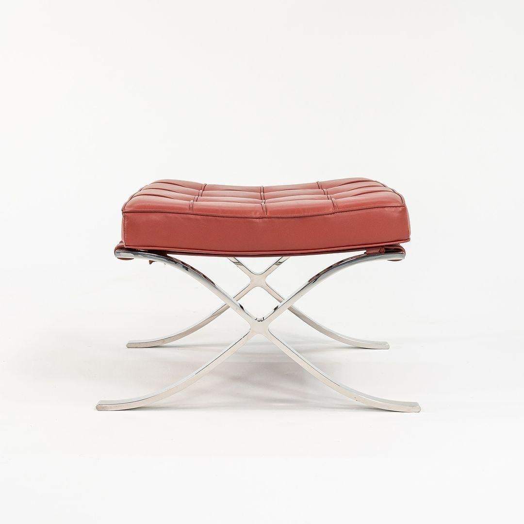 This is a circa 1960s production Barcelona stool or ottoman, produced by Knoll, with a leather seat and polished stainless steel frame. This came from the private collection of Gratz Industries and was masterfully restored by Gratz Industries within
