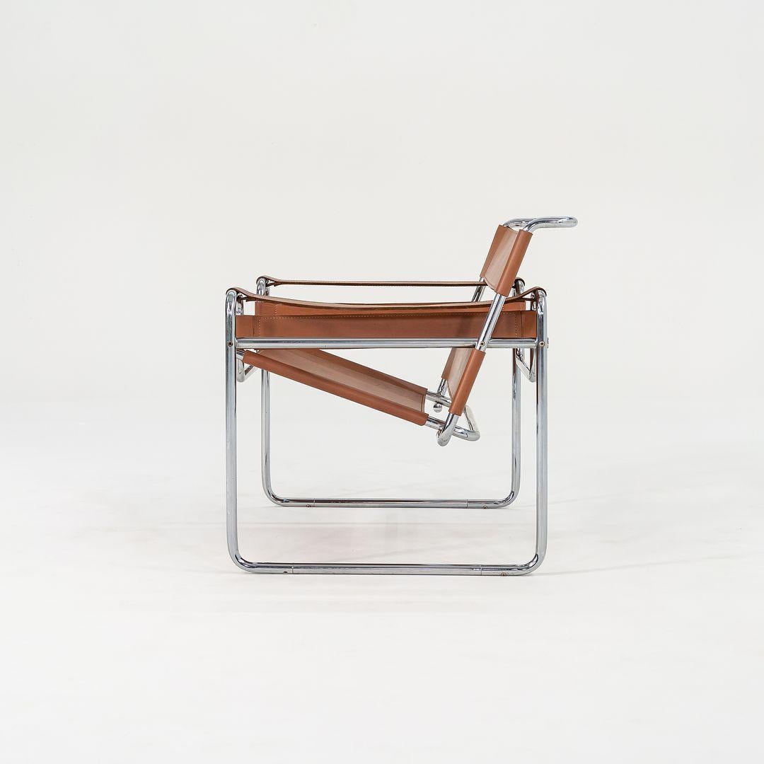 This is an original Wassily Lounge Chair, model B3, initially designed by Marcel Breuer in 1925. It has cognac brown leather upholstery and a chromed-steel frame that is tubular in nature, emblematic of Breuer's best-known works. This particular
