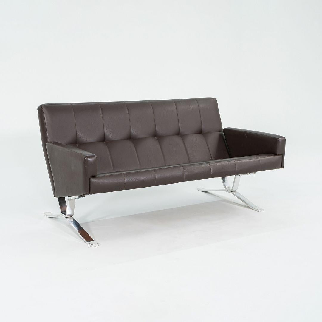 This is a Modern Brown Leather Settee Sofa, designed in 1966 by Dave Woods for the J.G. Furniture Company. The design was part of the Independent Suspension Group, introduced in Interiors Magazine in 1966. It has a highly polished steel frame, and