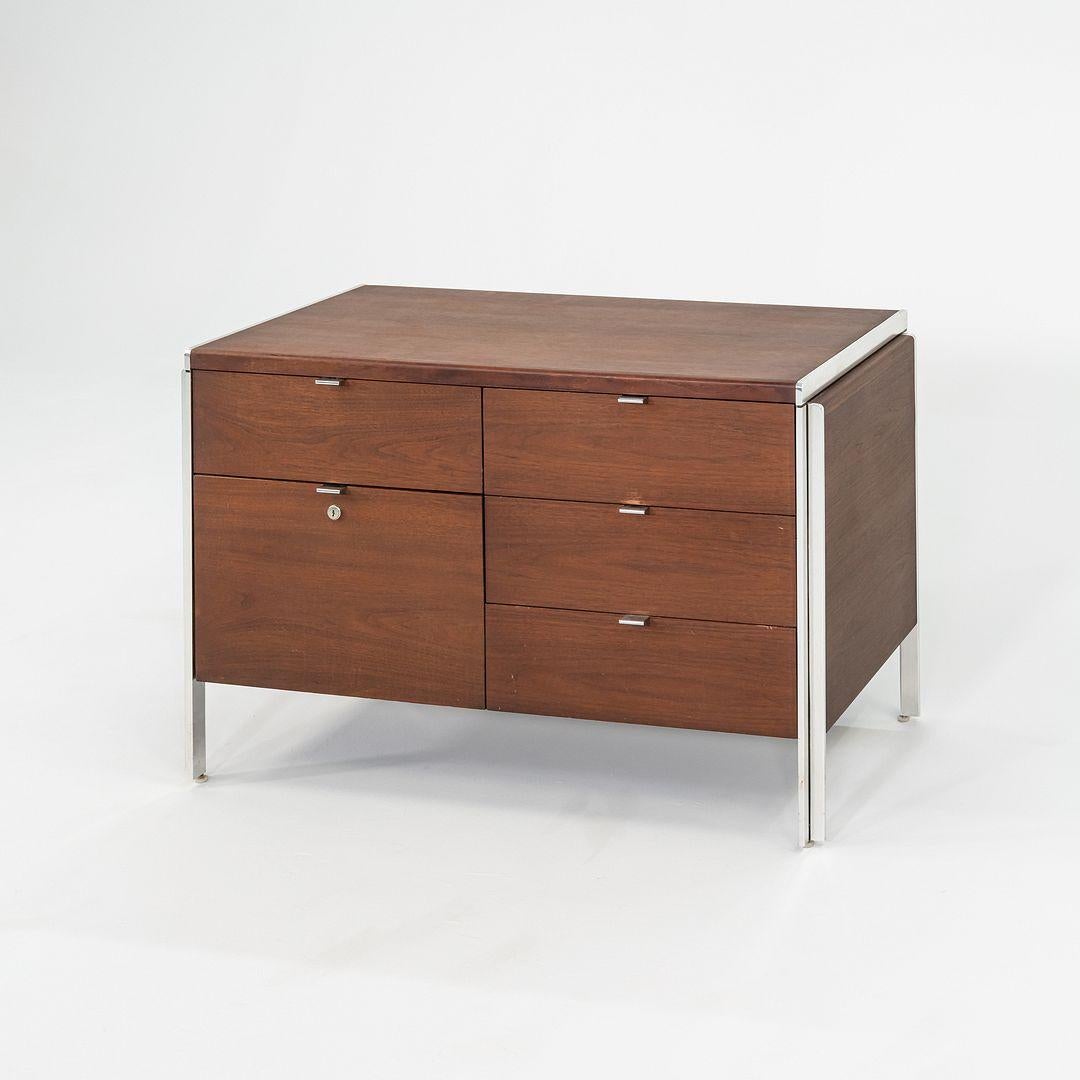 This is a Walnut Credenza from the 'Electa Series', designed by Interior Designer Alexis Yermakov for Stow Davis in 1968. The series featured freestanding pieces with heavy chromed steel frames, which supported interchangeable panels of walnut,