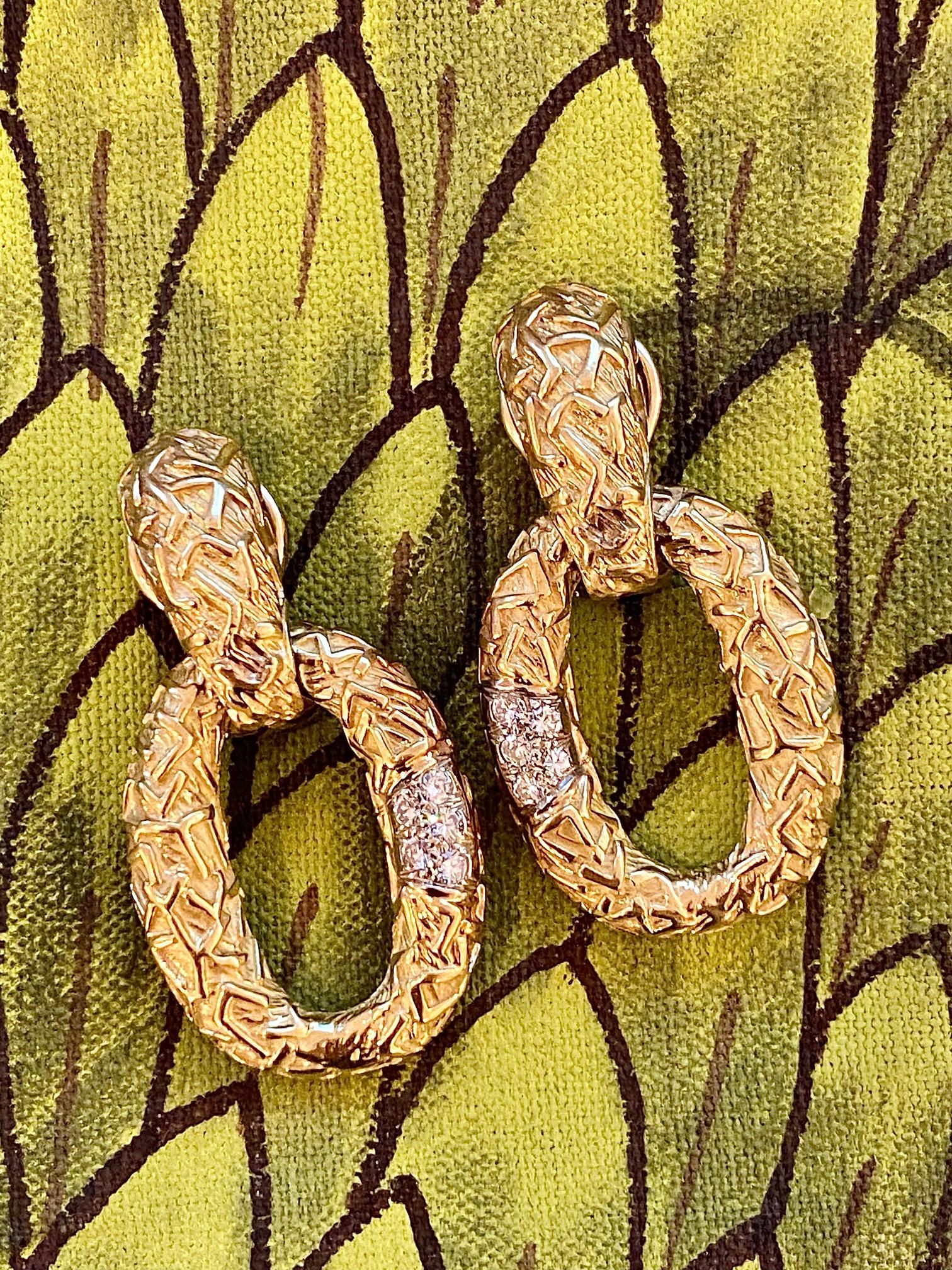 A pair of diamond and 18 karat gold clip earrings, by R. Stone, c. 1970, United States. 
Stamped © R. Stone 18K. 
Earrings measure 1.62