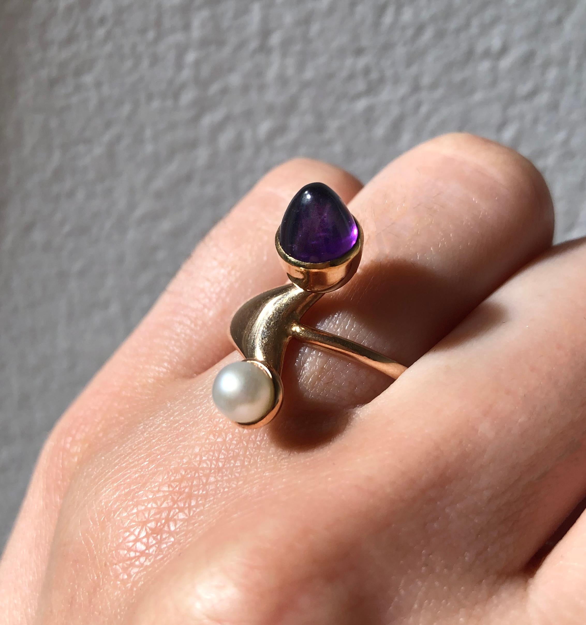 An amethyst, pearl and 14k gold ring, by Bent Knudsen, c. 1970s. Signed Denmark Bent K, stamped 585 8.  Ring size 6.75. This ring can be resized.

Bent Knudsen (1924 - 1996) was a renowned Danish modernist silversmith who, having worked at Hans