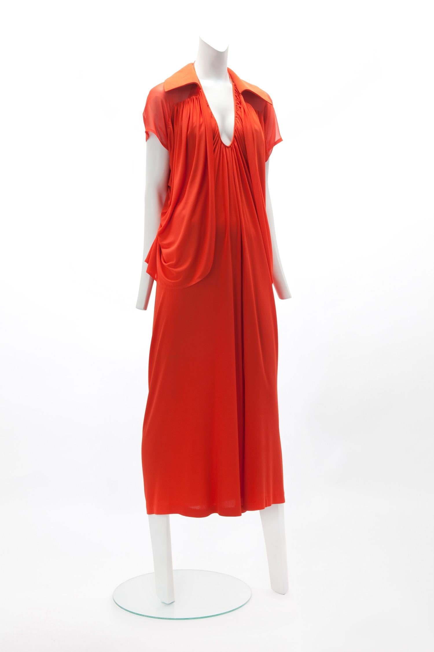 c. 1970s HALSTON Orange Matte Jersey Halter Dress with Matching Jacket; Draped U-Neckline with Cowl Back; Rouleau Strap with Hook and Eye Closure; Slit at Center Front; Short Sleeve Jacket with Chiffon Yoke; Labeled 