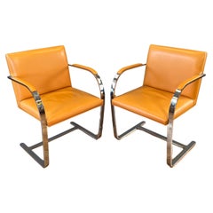 Two Gordon International Flat Bar Brno Armchairs in Orange Leather, circa 1970s