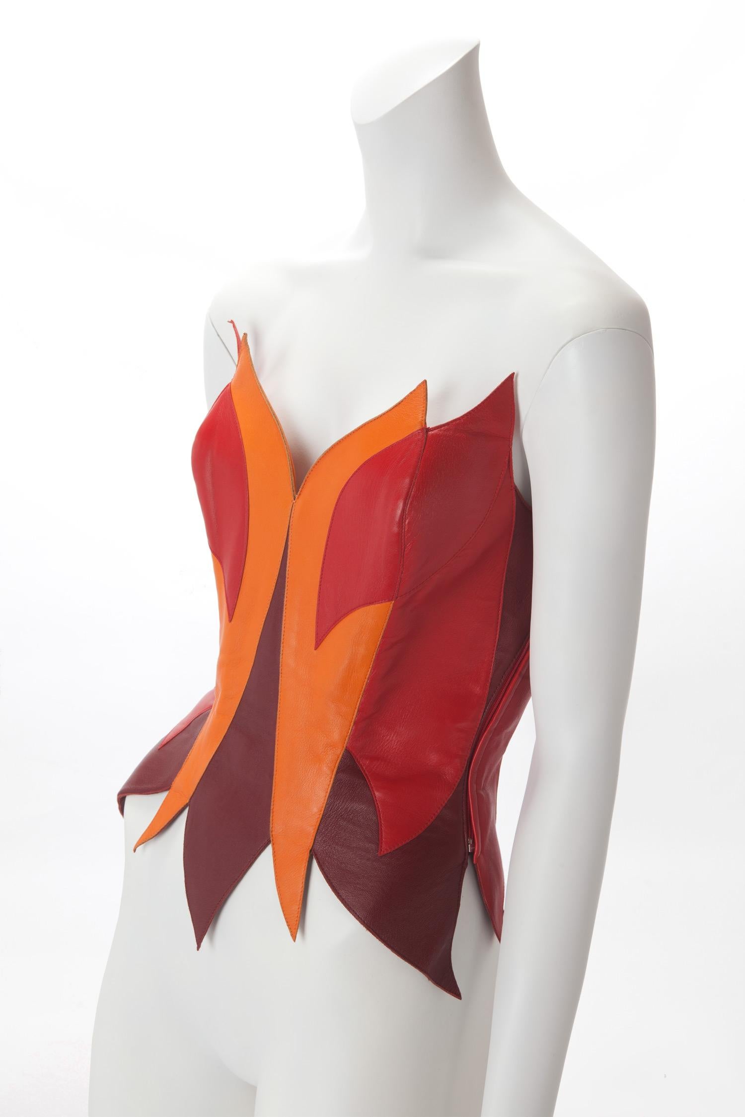 Rare Thierry Mugler Couture Leather Flame Bustier Museum c. 1980s; Colorblock leather flame pattern; Red silk lining; Side zipper closure. US size 4