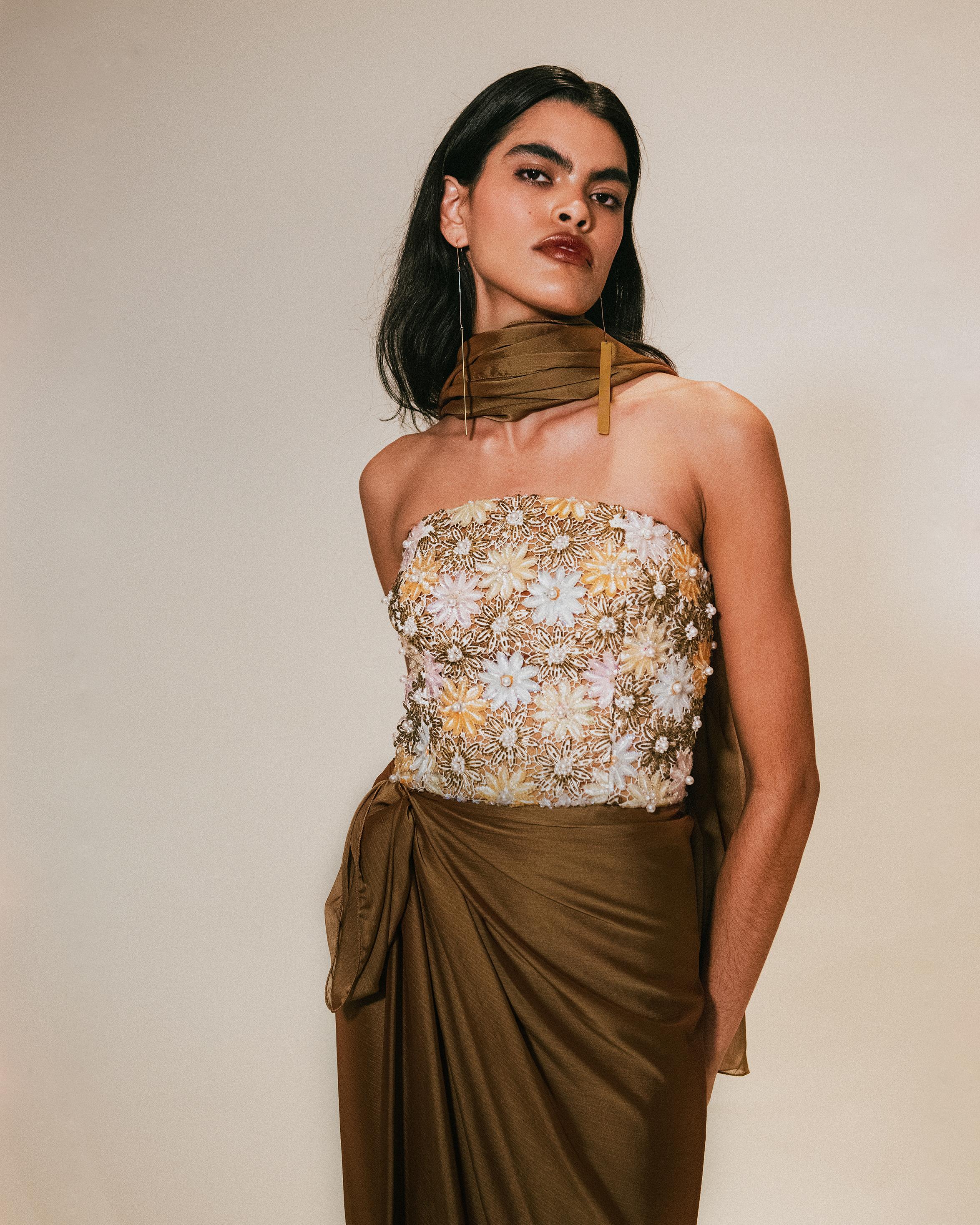 c. 1991 Nina Ricci embellished copper-brown strapless gown with stole. Upper features embellished, embroidered floral detailing with faux pearls at center of flowers. Built-in corset with boning. Silk gown has drape at hip and back zip closure. Can