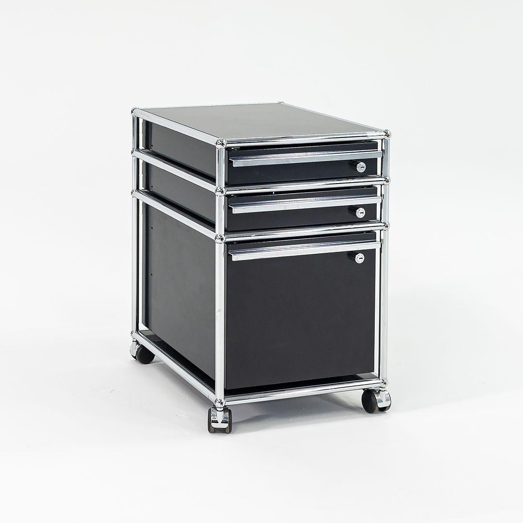 Listed for sale is a single USM Haller Pedestal (seven or more are available, though they are priced individually). It has three pull-out drawers, black powder coated steel panels, and polished chrome framing. We guarantee this to be an authentic