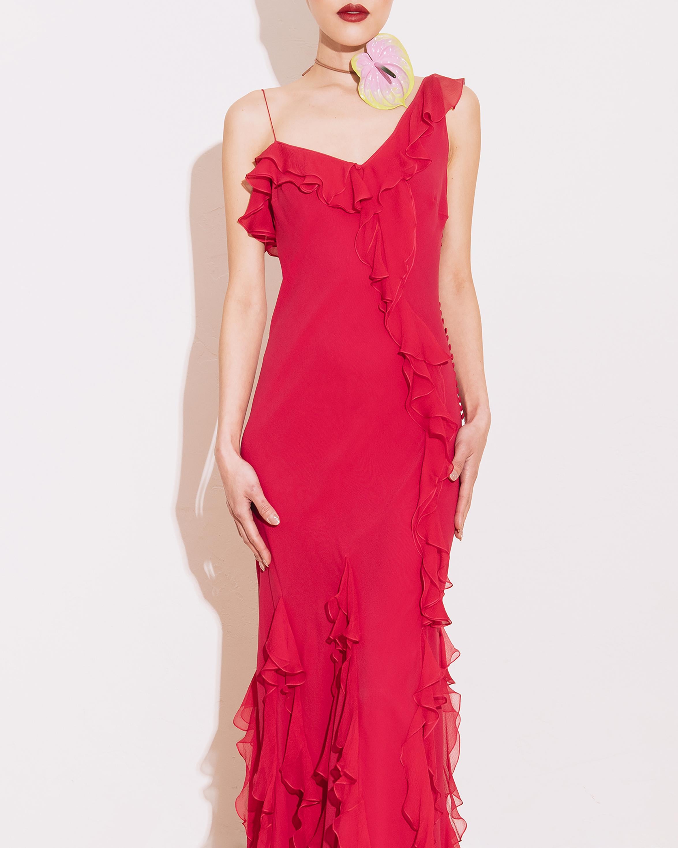 c. 2003 John Galliano pink asymmetrical silk chiffon bias cut gown with ruffle details. Galliano signature 1930's-inspired fabric buttons down side. V-neck with asymmetrical spaghetti strap and larger ruffle strap. Ruffles drape asymmetrically