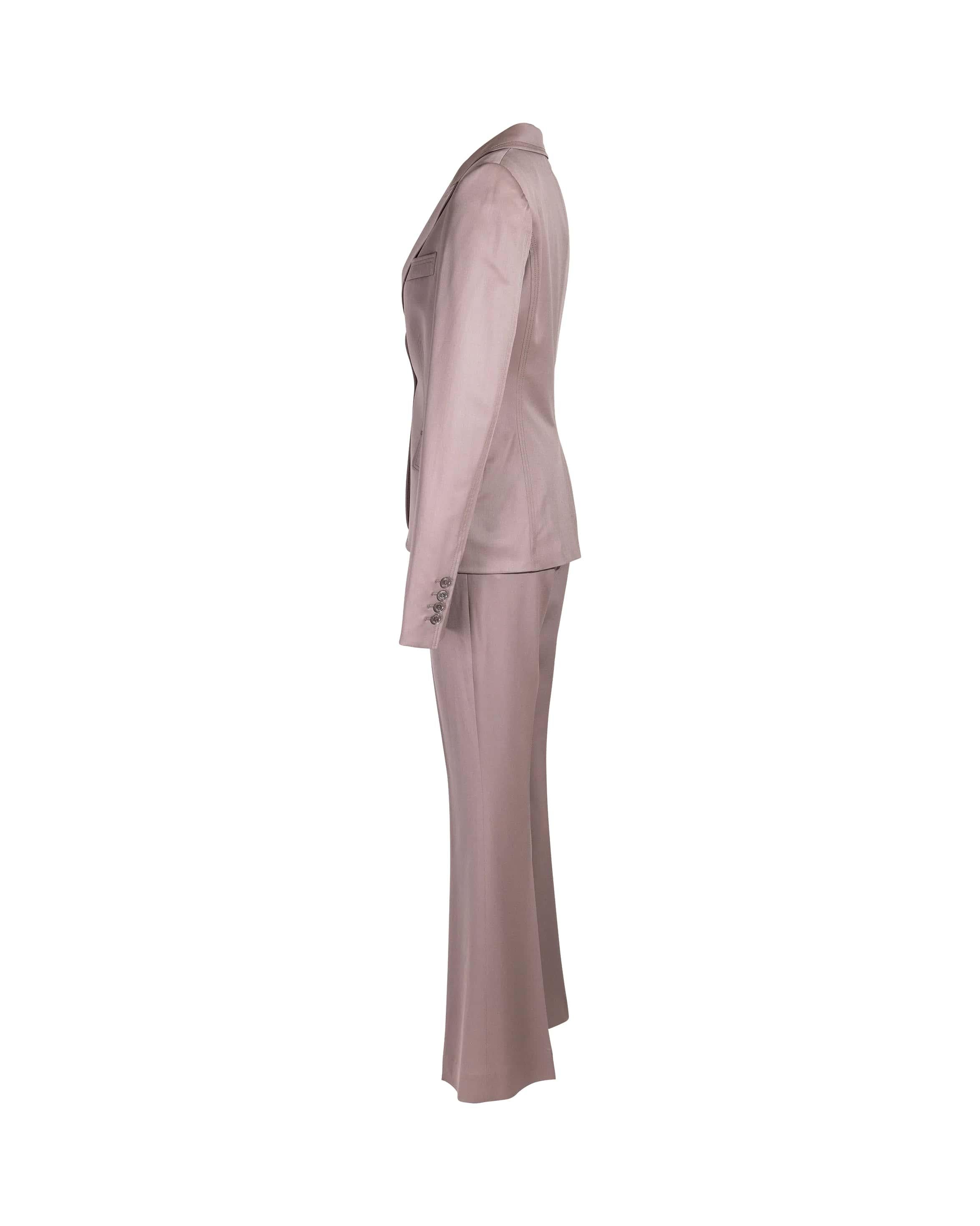 c. 2004 Gucci by Tom Ford beige wool blend pant suit set. Fitted double-stitched blazer with single button and flap pocket details. Blazer has slight padding at shoulders. Classic mid-rise trouser with functional side pockets.